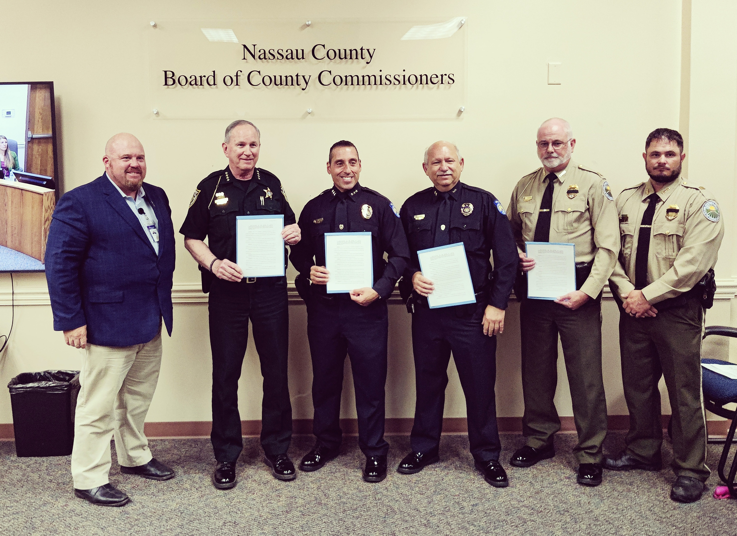 Commissioner Klynt Farmer poses with officers who were in attendance Monday to receive the proclamation declaring May 12-18 as National Police Week and May 15 as Peace Officers Memorial Day in Nassau County. Photo by Ashley Chandler/News-Leader
