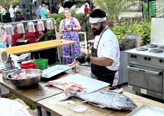 Omni Resort executive chef Omar Collazo is pictured preparing his winning recipe during last weekend’s Fish to Fork competition at the Omni.