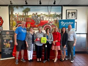 Pictured are, from left,  Barnabas board member John Mullman, Barnabas board member Maureen Paschke, Barnabas board member Liza Cotter, Firehouse Subs Public Safety Foundation Executive Director Robin Peters, Barnabas President and CEO Jamie Reynolds, Baptist Health Community Relations coordinator Avalee Delay, and Barnabas board member Rev. Joe Woodfin. Photo courtesy of Barnabas Center