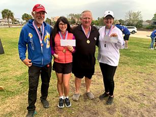 First-place winners in the Federation Pétanque USA Southeast Regional Mixed Doubles Tournament on March 12 were Raymond Nielsen and Erica Nielsen, and secondplace finishers were Gary Montgomery and Tina Lamas, pictured from left. Submitted photo