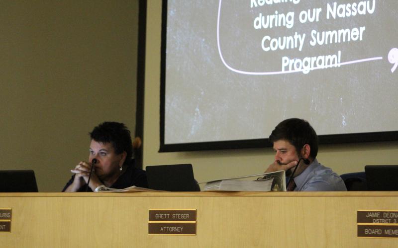 Superintendent Kathy Burns and attorney Brett Steger watch a video presentation from the district on the 2022 summer school session. Photo by Holly Dorman.