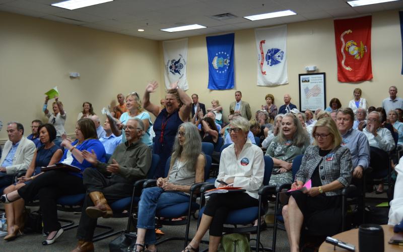 Concerned residents celebrate the County Commission’s decision to stand with its building height ordinance. Marissa Mahoney/News-Leader