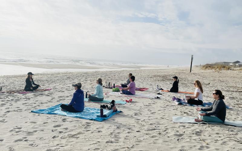 Deb Cunningham starting her Sunday morning beach yoga class.