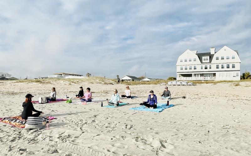 Beach yoga class in front of Elizabeth Point Lodge.