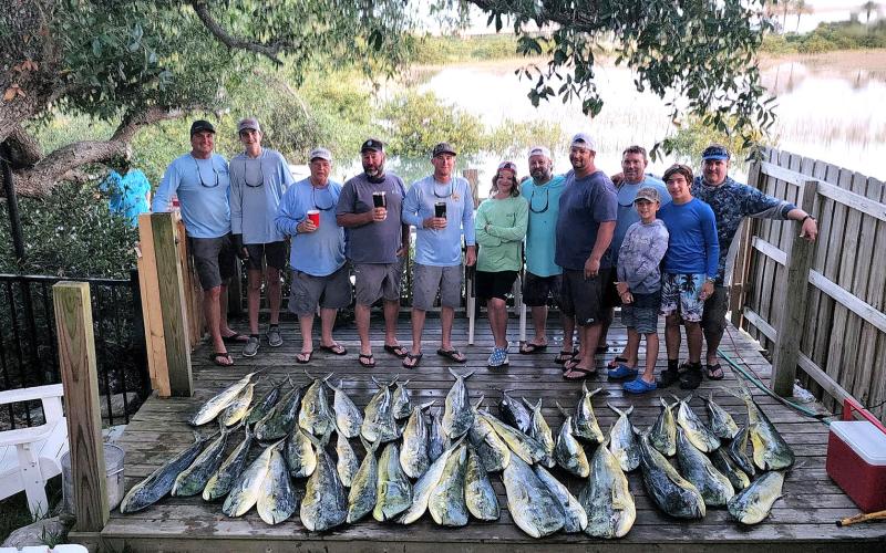 Steve Pickett and his family and friends are pictured with a big catch of hard-fighting, colorful and delicious blue water dolphin. Submitted photo