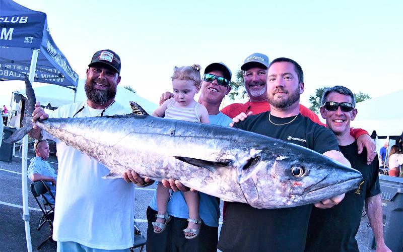 Last year, team Good Problem weighed in the largest kingfish at 51.3 pounds for first-place honors and a check for $7,500. Pictured are, from left, Brad Ecklof, Ben Langley and daughter Sadi, Taj Delong, boat captain James Powell and Joe Lassiter. Photo by Terry Lacoss/Special