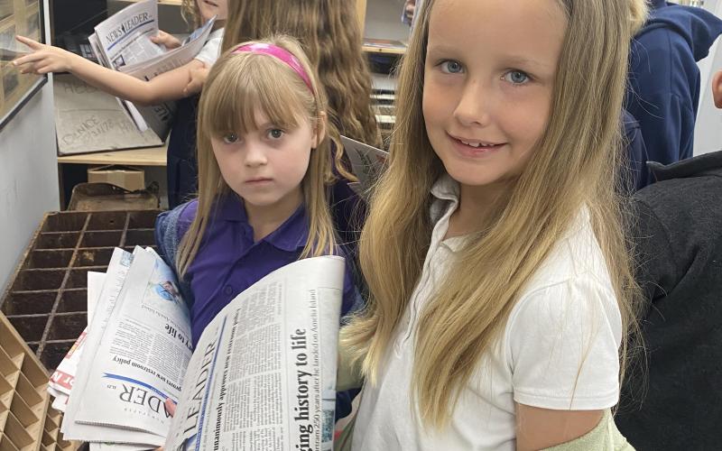 FBCA third grade student Lucy Bird looks over a copy of the News-Leader on a field trip to the newspaper office. Photo by Tracy McCormick-Dishman/News-Leader