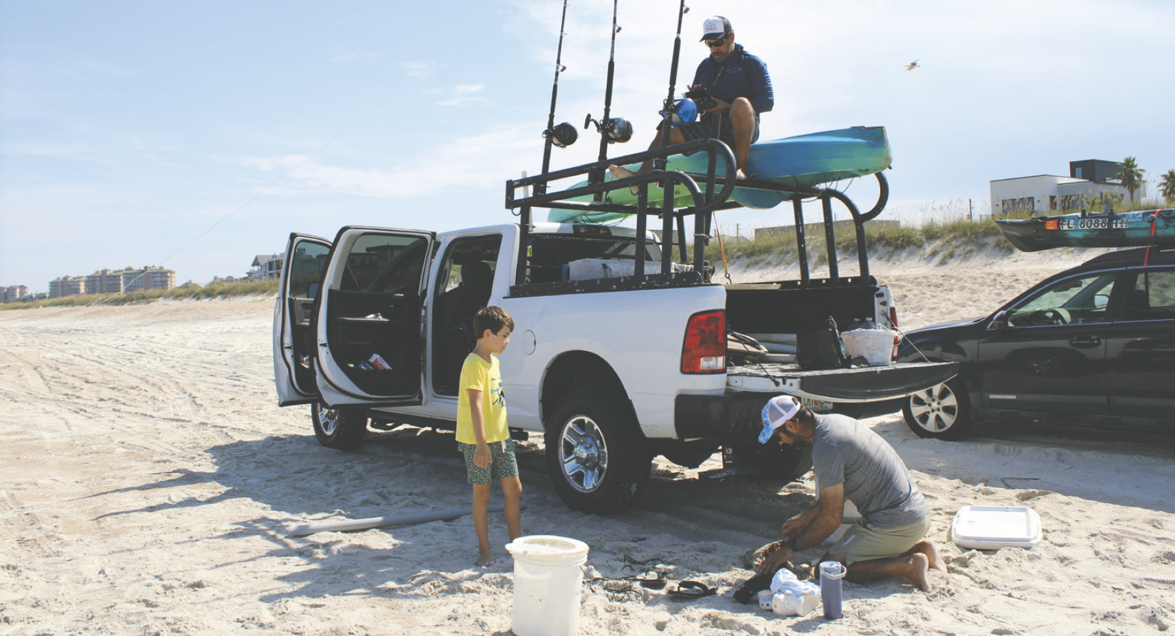 Alberto Vanegas, James Davis and his son Duncan setting up for shark fishing. Photo by Marisa DeMar/News-Leader