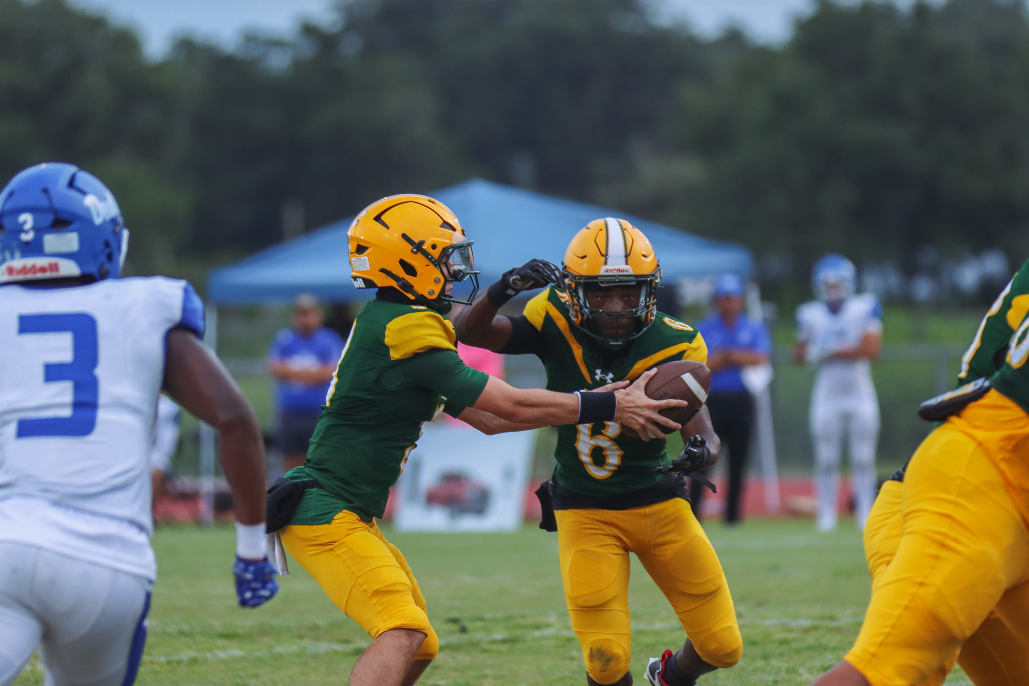 Ashley Chandler/News-Leader Tre Vazquez hands the ball to Jayden Timmon in week two.