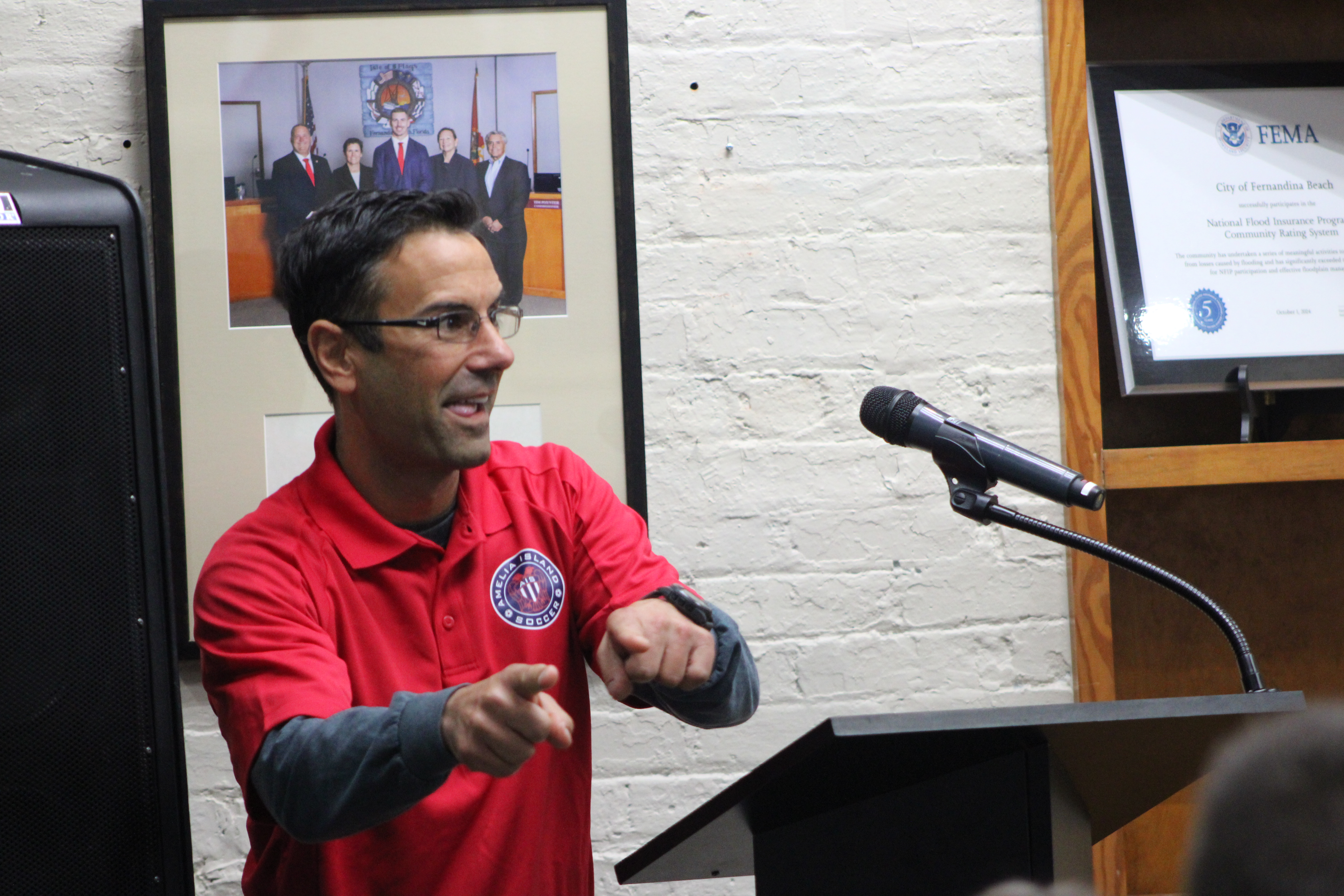 Andy Francis, coach of Amelia Island Soccer motions to the young girls he coaches at Amelia Island Youth Soccer while advocating for the program.  By Marisa DeMar/News-Leader 