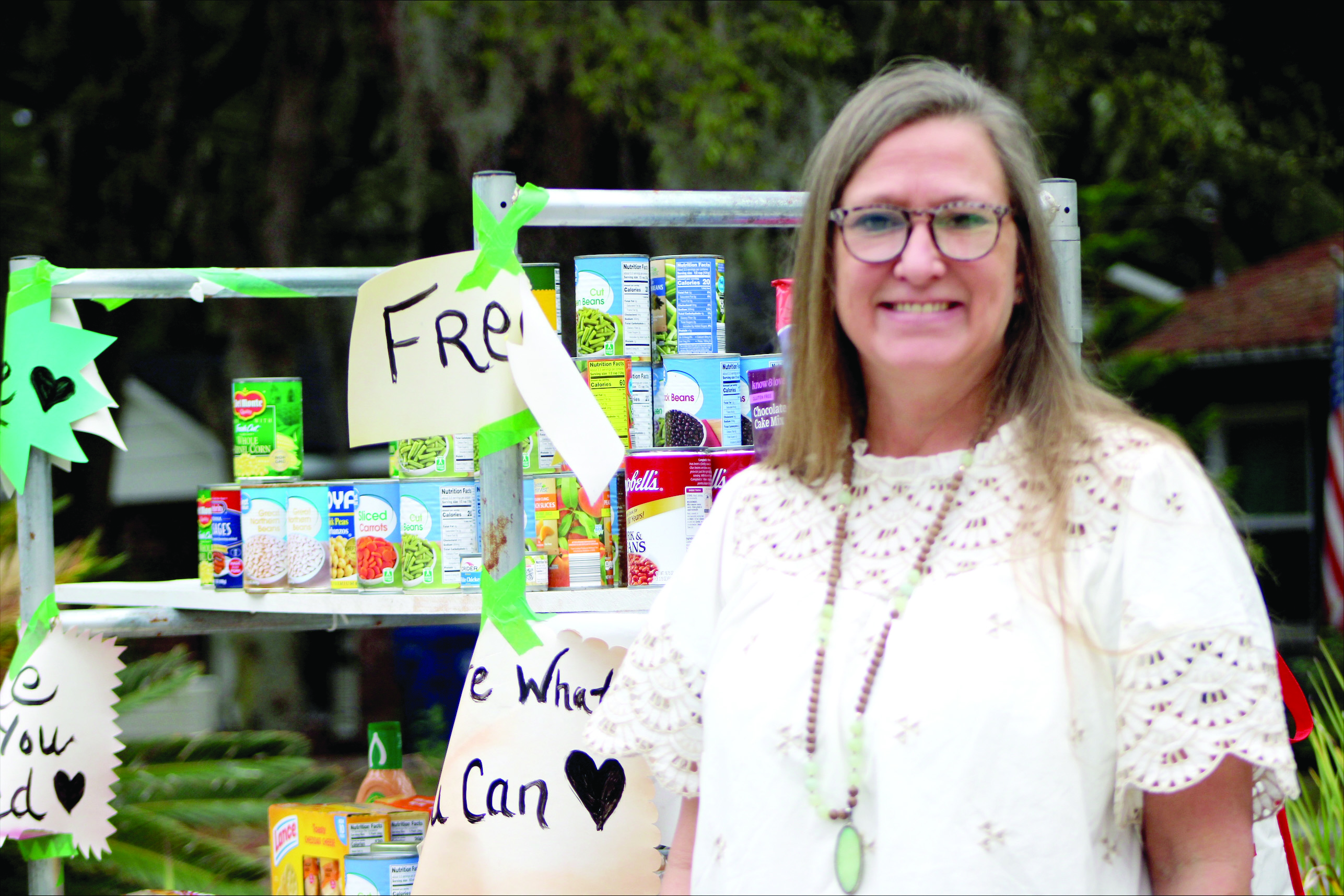 Becky Dewitt stands next to her front yard food pantry on S 14th Street after the code enforcement officer visited her home.  By Marisa DeMar/News-Leader 