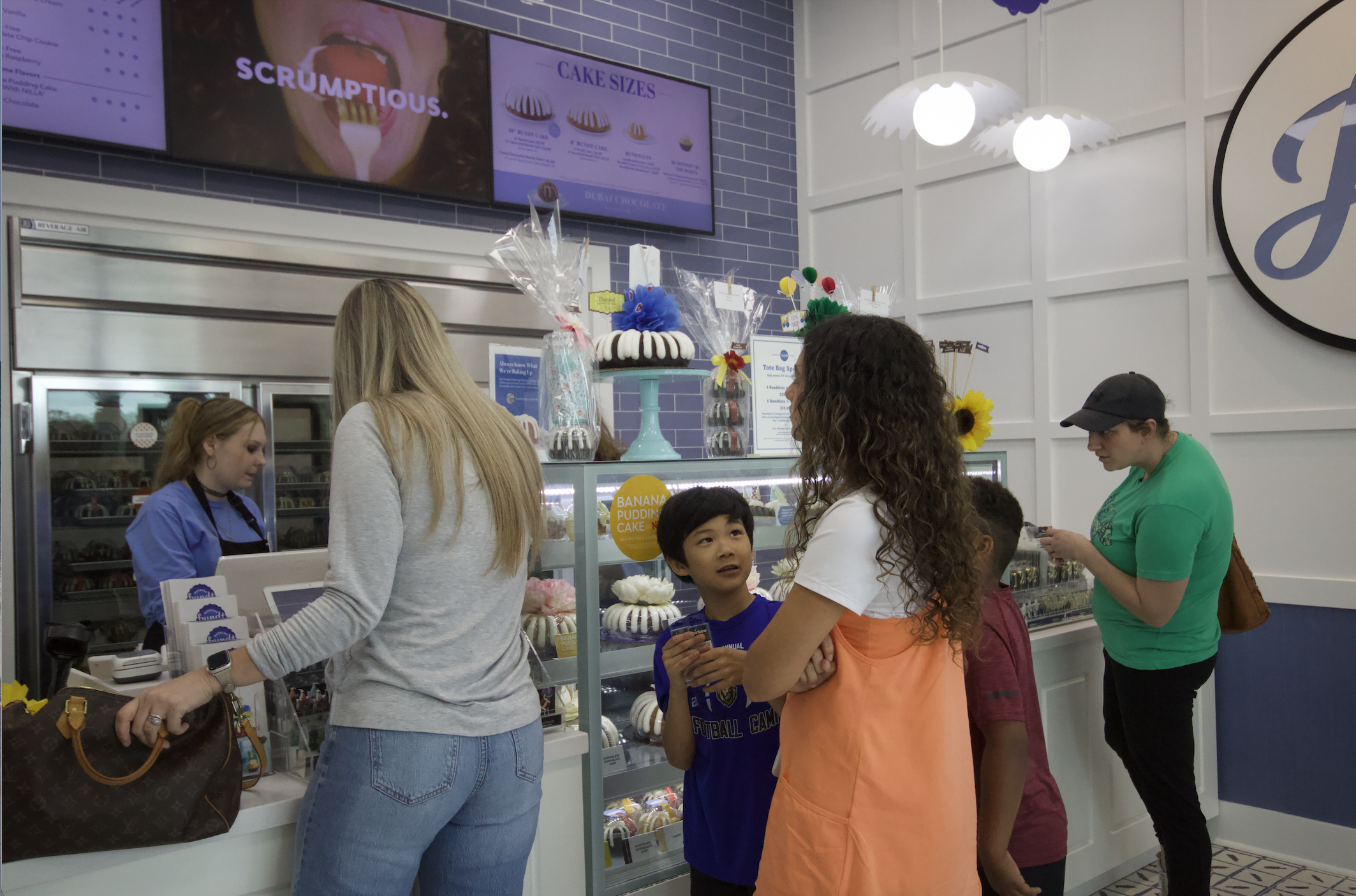Customers line up to purchase cakes during the soft opening of Nothing Bundt Cakes in Yulee on Monday. By Marisa DeMar 