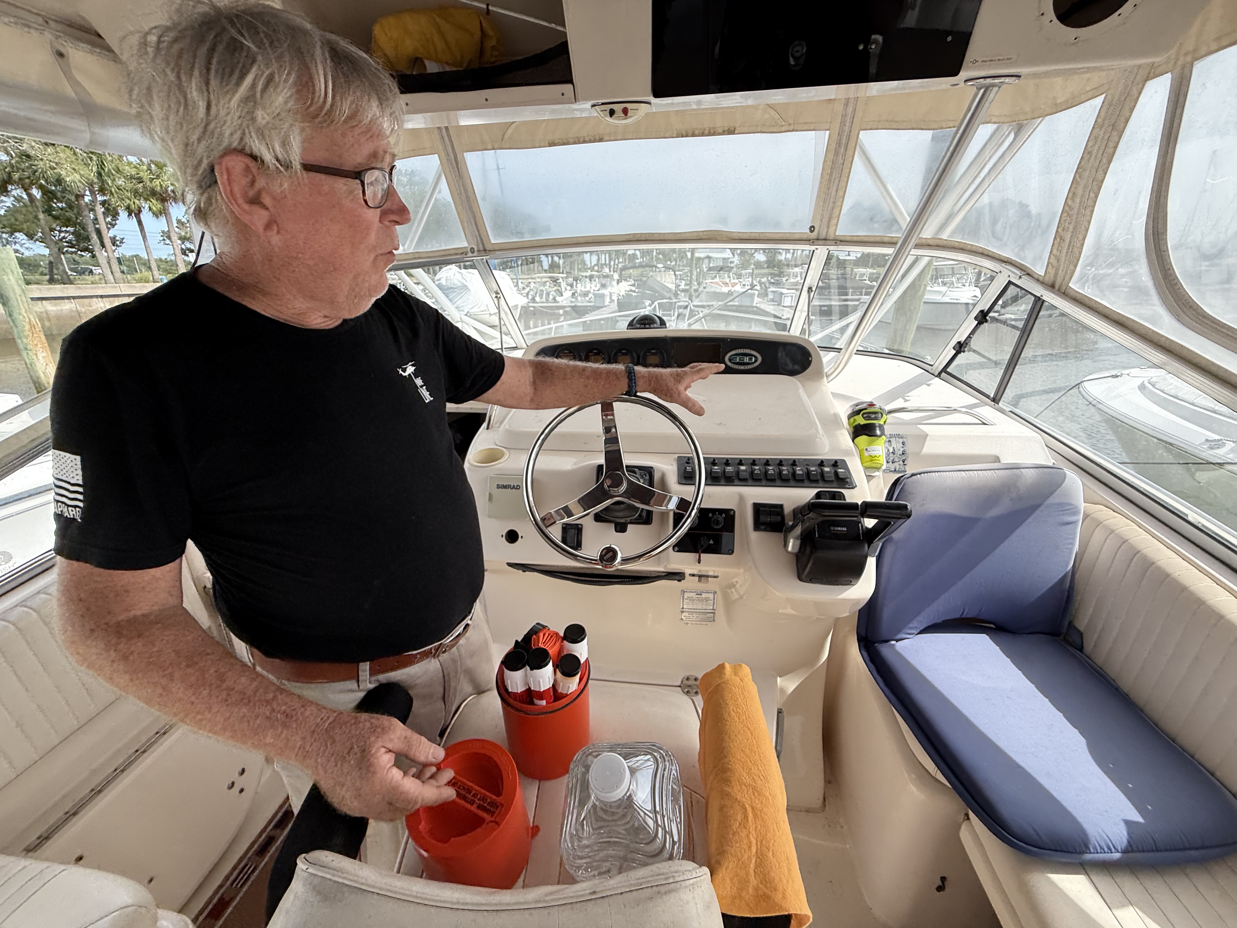 Leo Radkowski shows safety equipment on his boat at the Amelia Island Marina on Wednesday. 