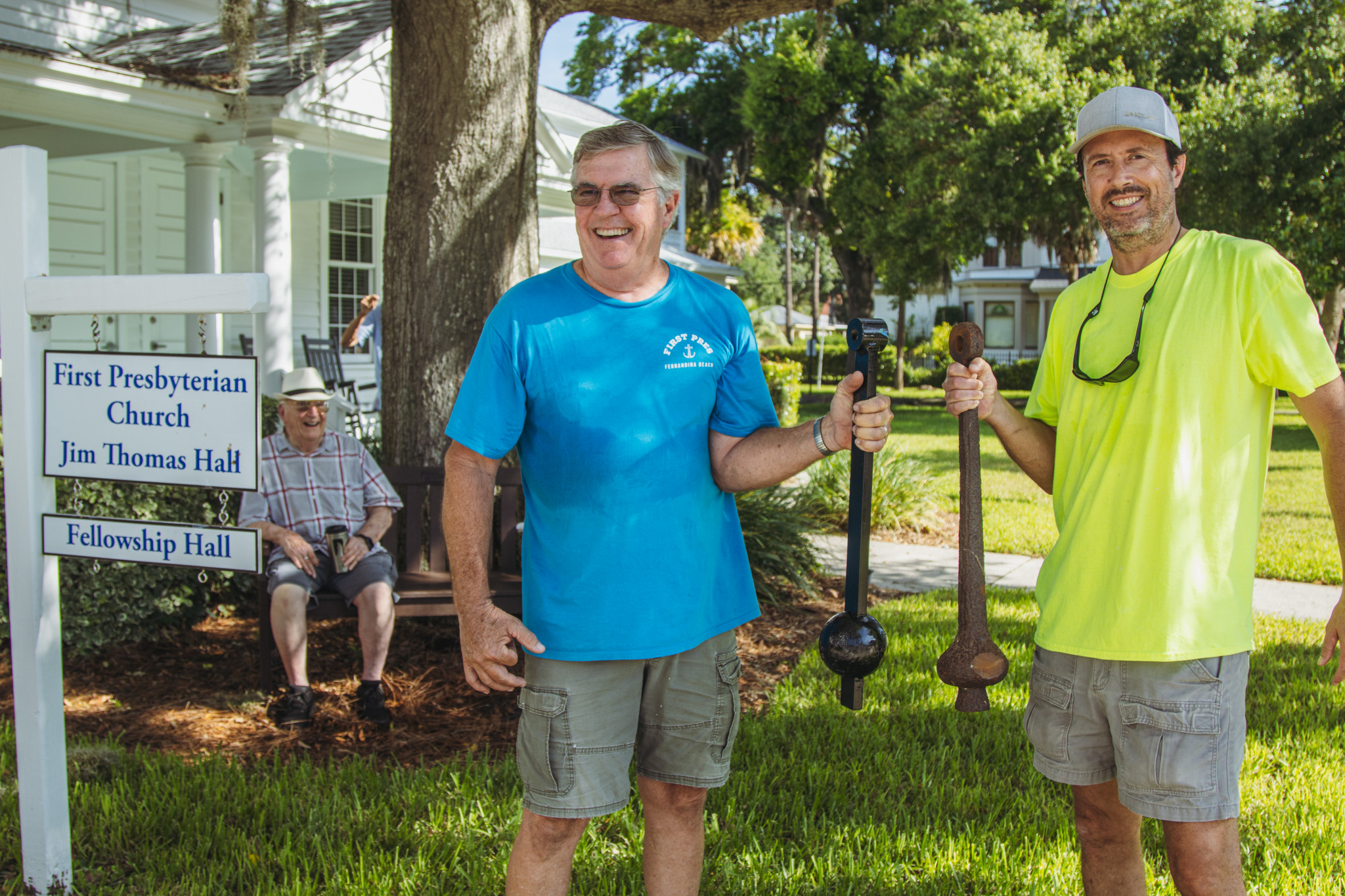 Tom Keenan holds the new clapper and Nate Whitaker holds the old clapper from the historic First Presbyterian Church bell on Tuesday. Photo by Ashley Chandler/News-Leader