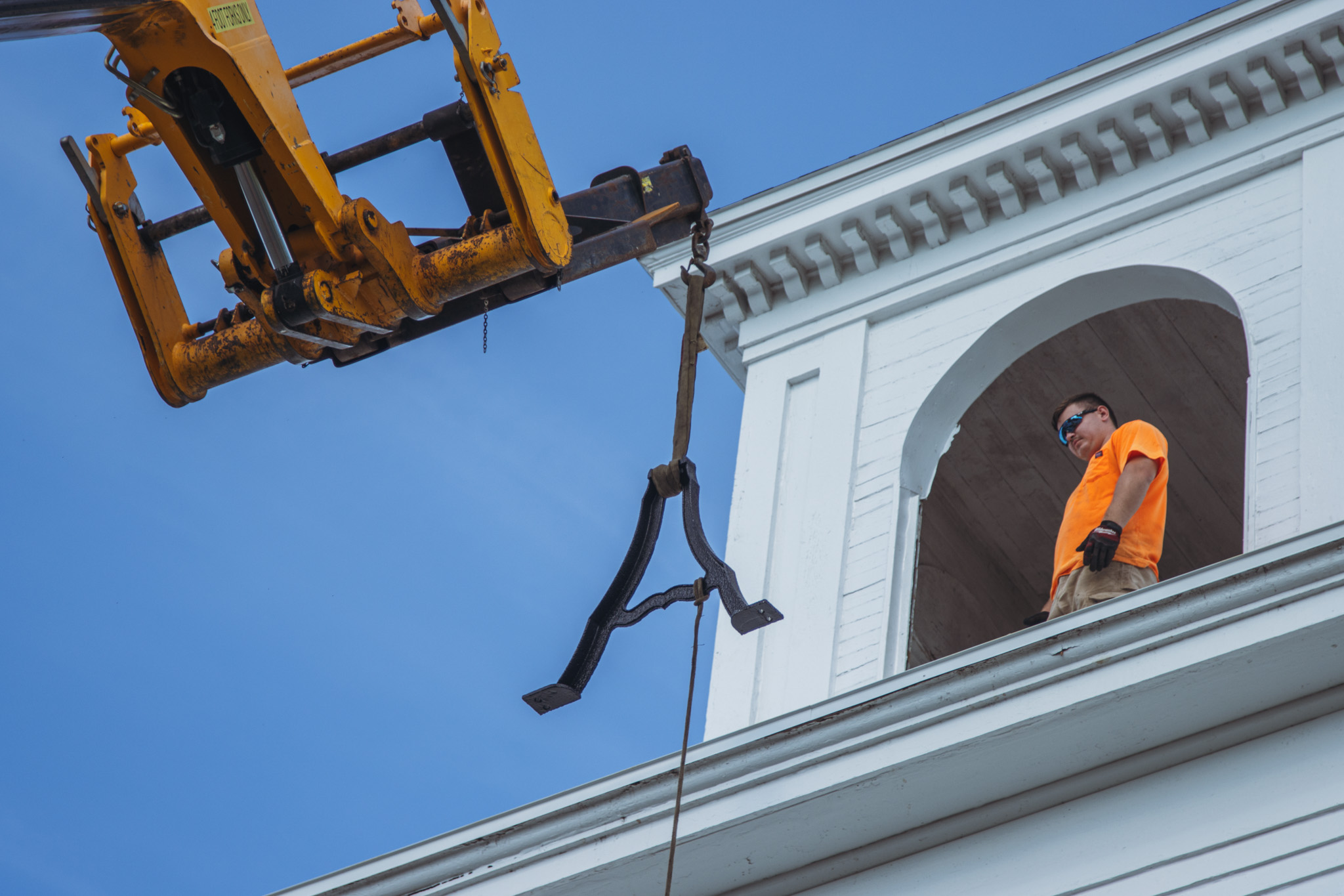 Workers from White’s Clock and Carillon assemble and place the restored bell in its place in the First Presbyterian Church belfry on Tuesday in Downtown Fernandina Beach. Photo by Ashley Chandler/News-Leader