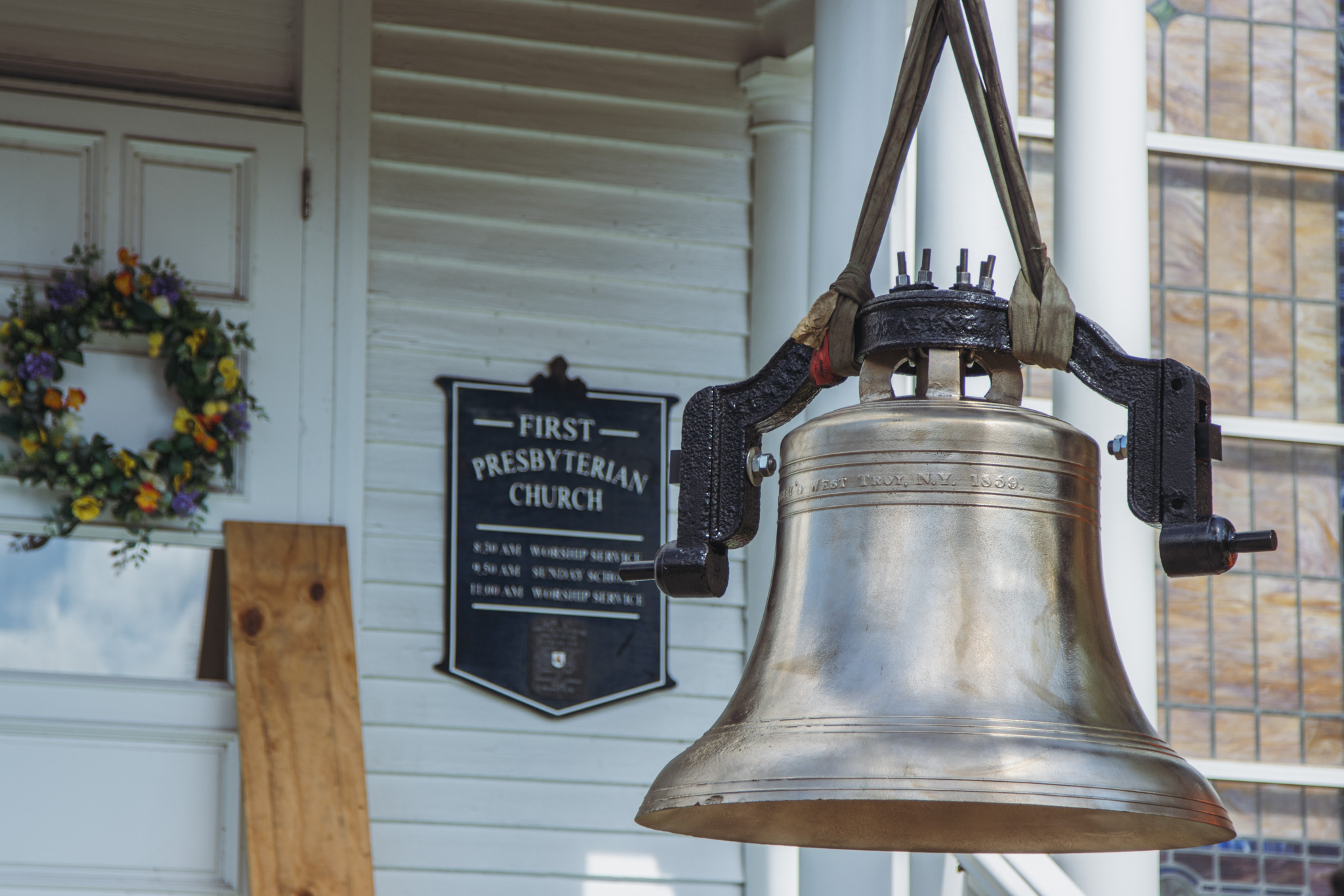 Workers from White’s Clock and Carillon assemble and place the restored bell in its place in the First Presbyterian Church belfry on Tuesday in Downtown Fernandina Beach. Photo by Ashley Chandler/News-Leader