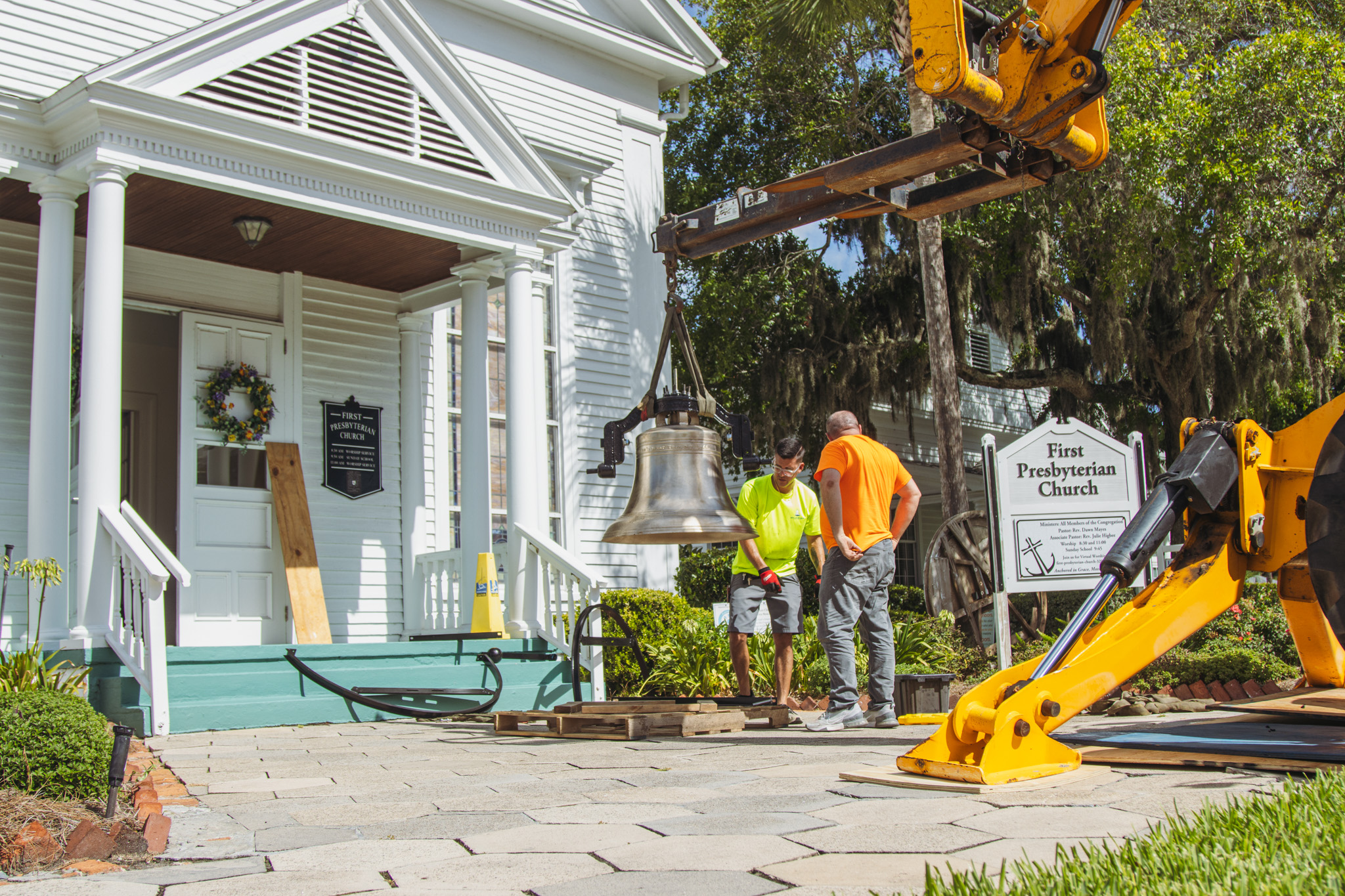 Workers from White’s Clock and Carillon assemble and place the restored bell in its place in the First Presbyterian Church belfry on Tuesday in Downtown Fernandina Beach. Photo by Ashley Chandler/News-Leader