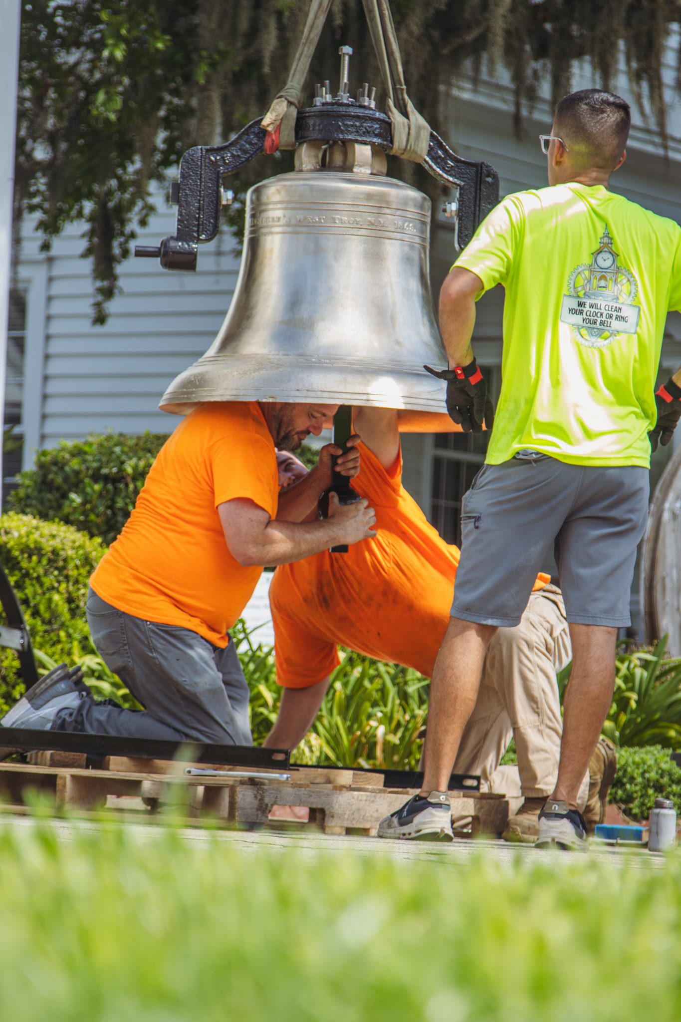 Workers from White’s Clock and Carillon assemble and place the restored bell in its place in the First Presbyterian Church belfry on Tuesday in Downtown Fernandina Beach. Photo by Ashley Chandler/News-Leader