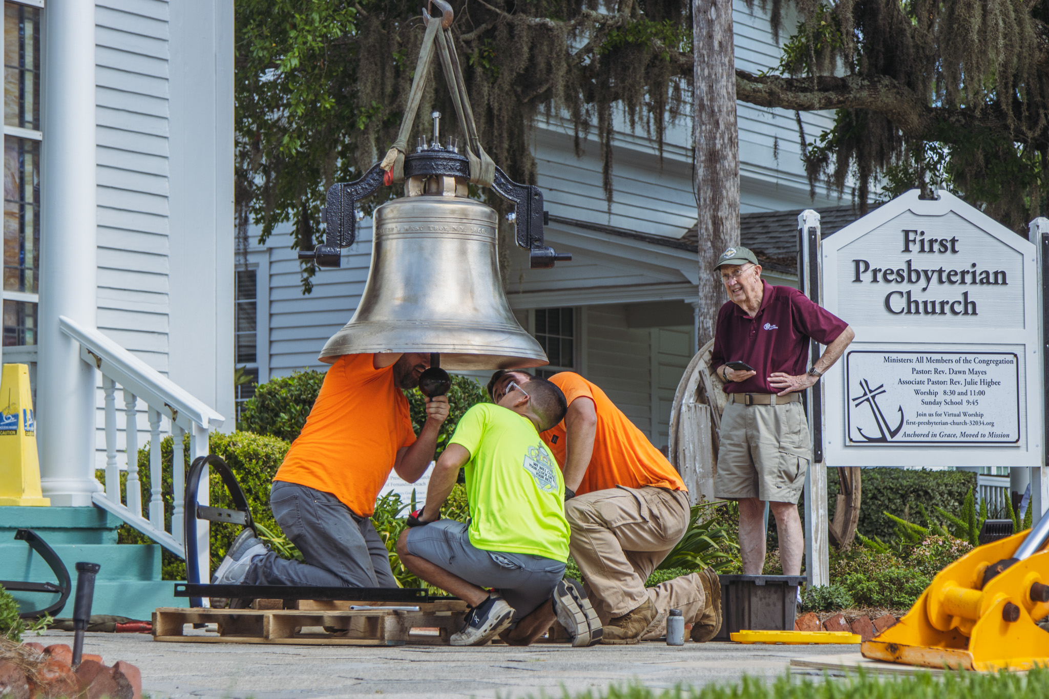 Workers from White’s Clock and Carillon assemble and place the restored bell in its place in the First Presbyterian Church belfry on Tuesday in Downtown Fernandina Beach. Photo by Ashley Chandler/News-Leader