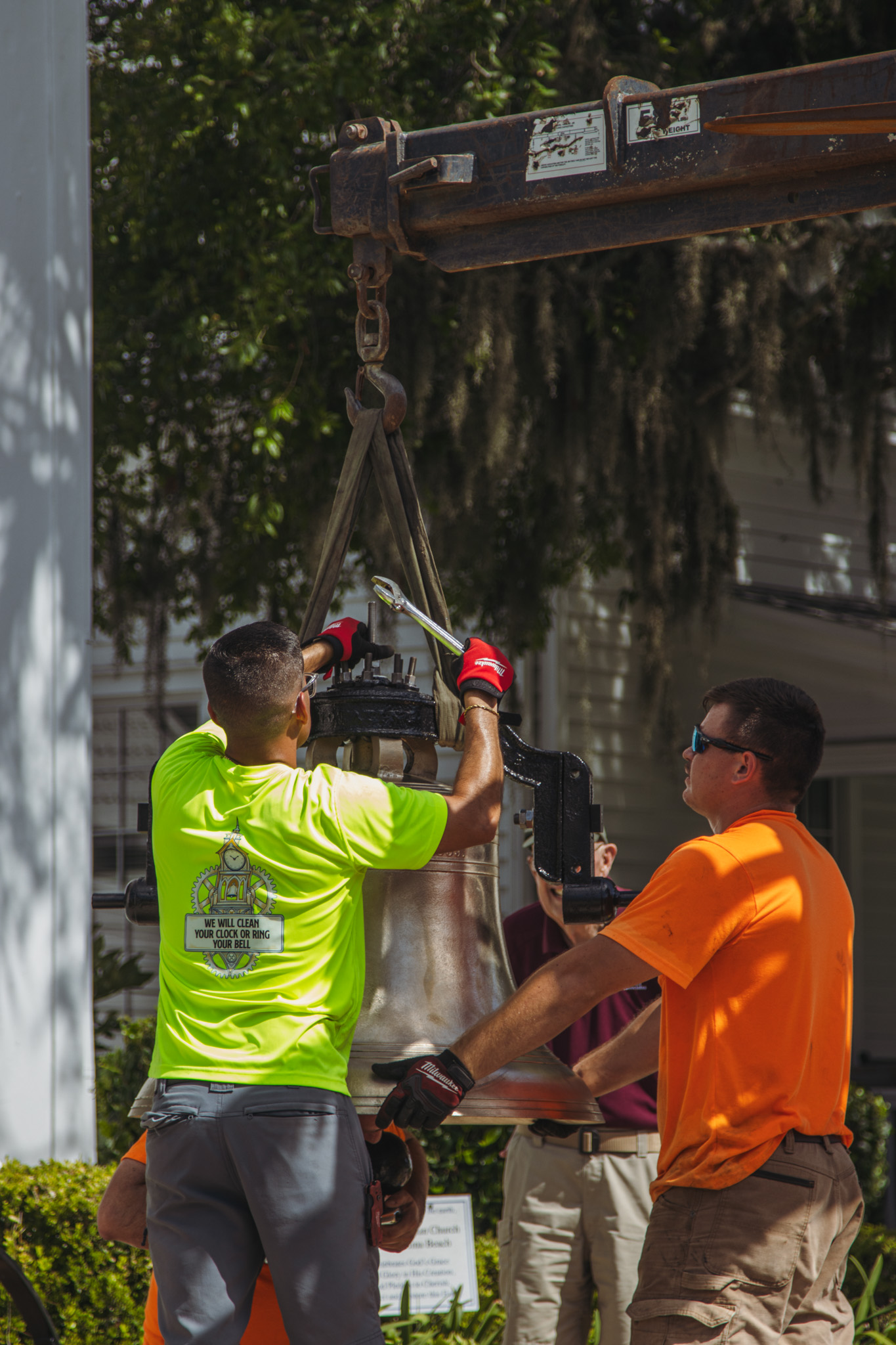 Workers from White’s Clock and Carillon assemble and place the restored bell in its place in the First Presbyterian Church belfry on Tuesday in Downtown Fernandina Beach. Photo by Ashley Chandler/News-Leader