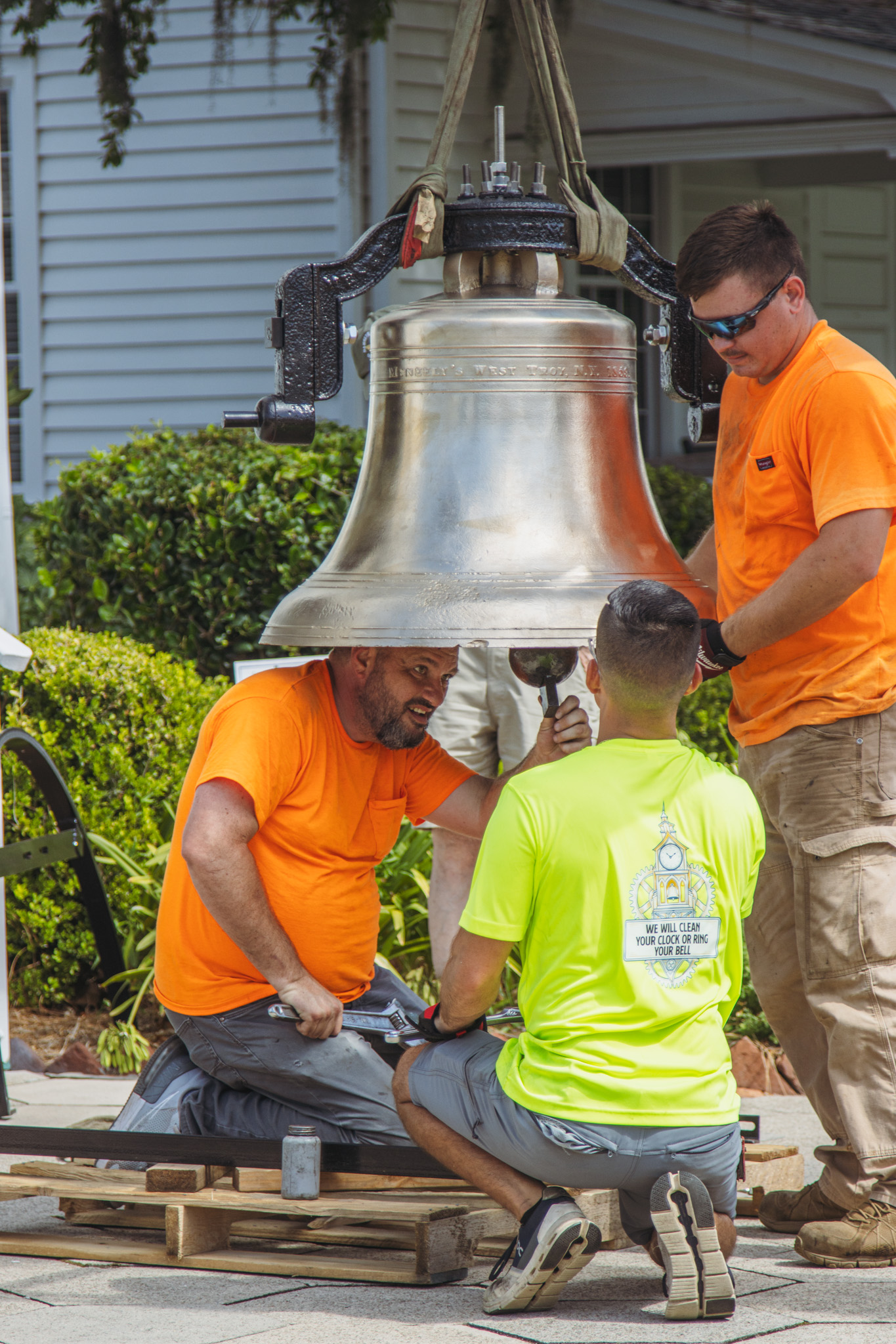 Workers from White’s Clock and Carillon assemble and place the restored bell in its place in the First Presbyterian Church belfry on Tuesday in Downtown Fernandina Beach. Photo by Ashley Chandler/News-Leader