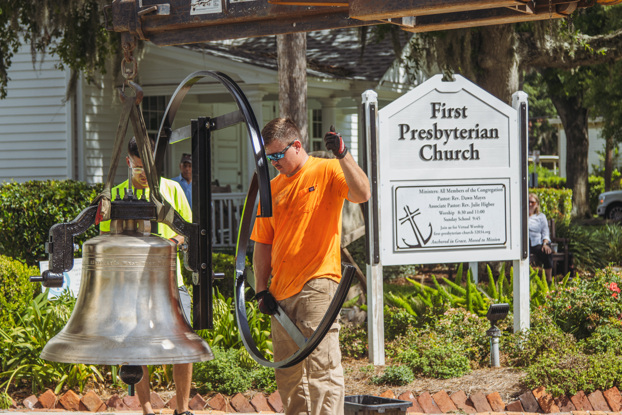 Workers from White’s Clock and Carillon assemble and place the restored bell in its place in the First Presbyterian Church belfry on Tuesday in Downtown Fernandina Beach. Photo by Ashley Chandler/News-Leader