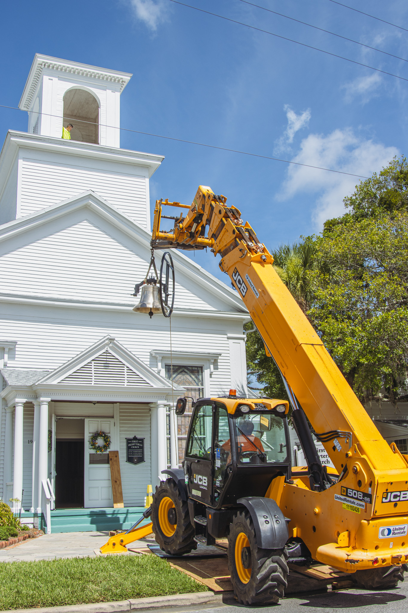Workers from White’s Clock and Carillon assemble and place the restored bell in its place in the First Presbyterian Church belfry on Tuesday in Downtown Fernandina Beach. Photo by Ashley Chandler/News-Leader
