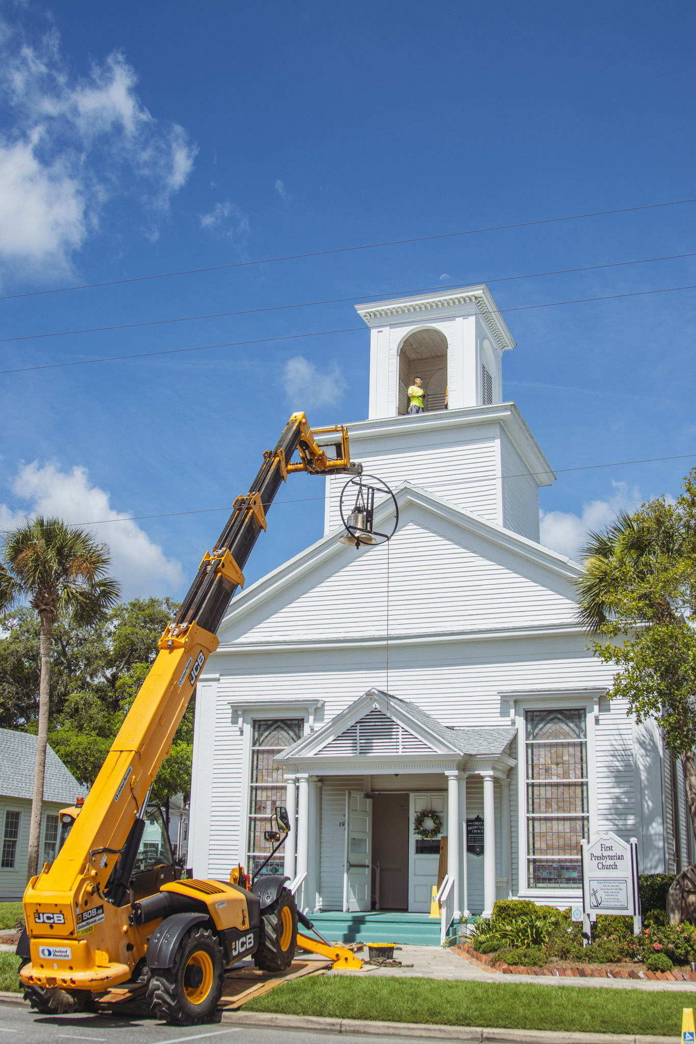 Workers from White’s Clock and Carillon assemble and place the restored bell in its place in the First Presbyterian Church belfry on Tuesday in Downtown Fernandina Beach. Photo by Ashley Chandler/News-Leader
