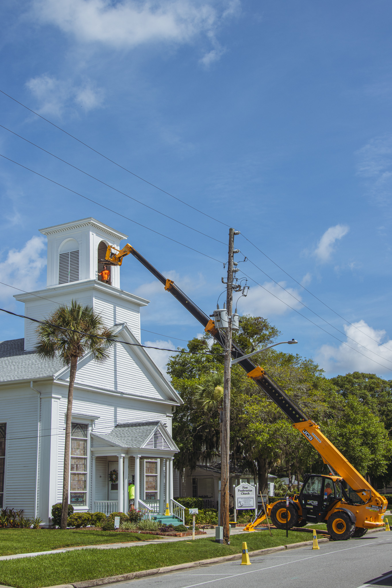 Workers from White’s Clock and Carillon assemble and place the restored bell in its place in the First Presbyterian Church belfry on Tuesday in Downtown Fernandina Beach. Photo by Ashley Chandler/News-Leader