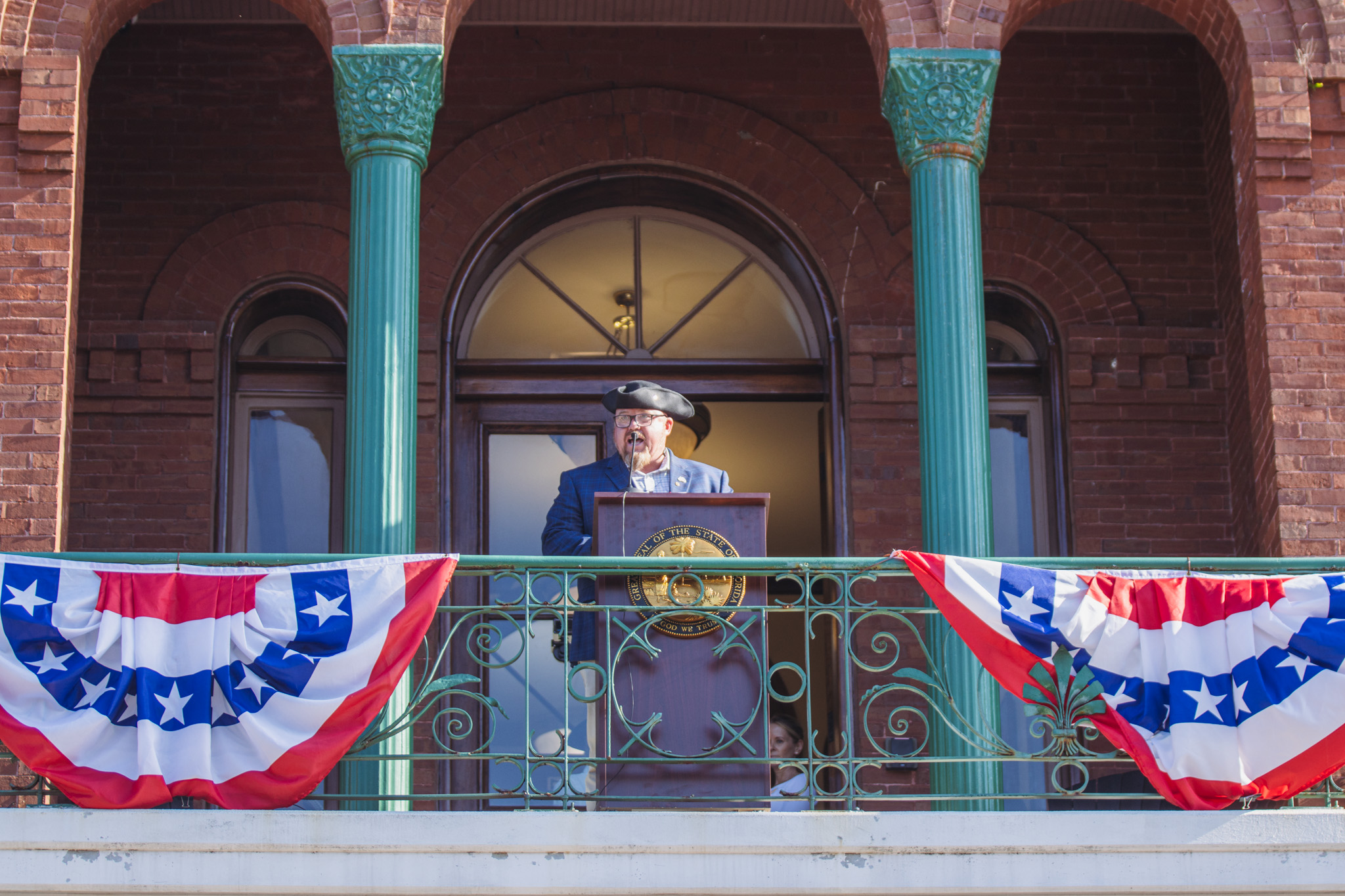 Nassau County Commissioner Klynt Farmer reads part of the Declaration of Independence. Photo by Ashley Chandler/News-Leader