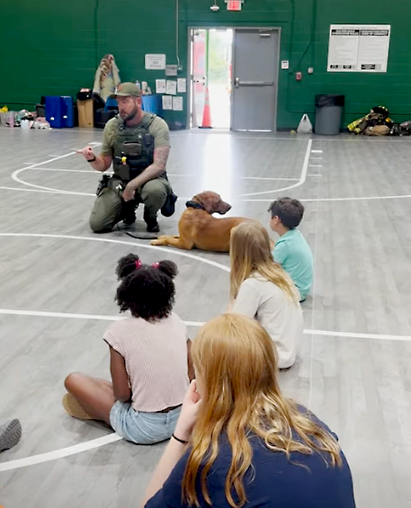 A deputy speaks to children at the radKIDS camp in Yulee. Submitted photo