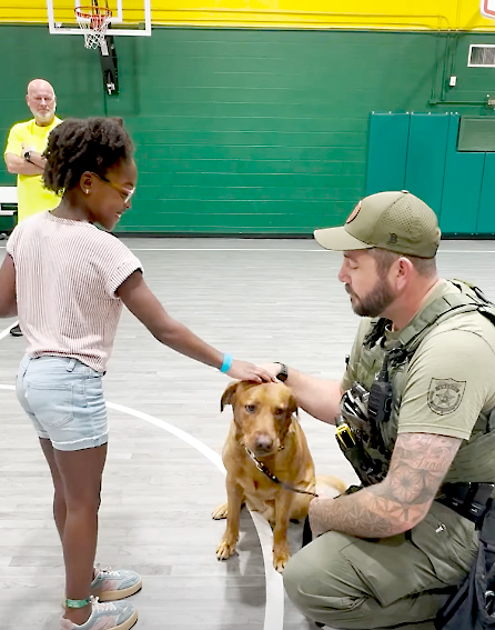 A deputy speaks to children at the radKIDS camp in Yulee. Submitted photo