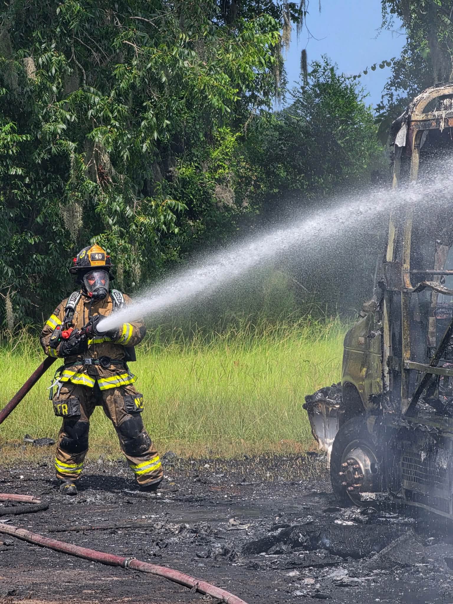 A Nassau County firefighter battles the blaze Friday on County Road 121. Submitted