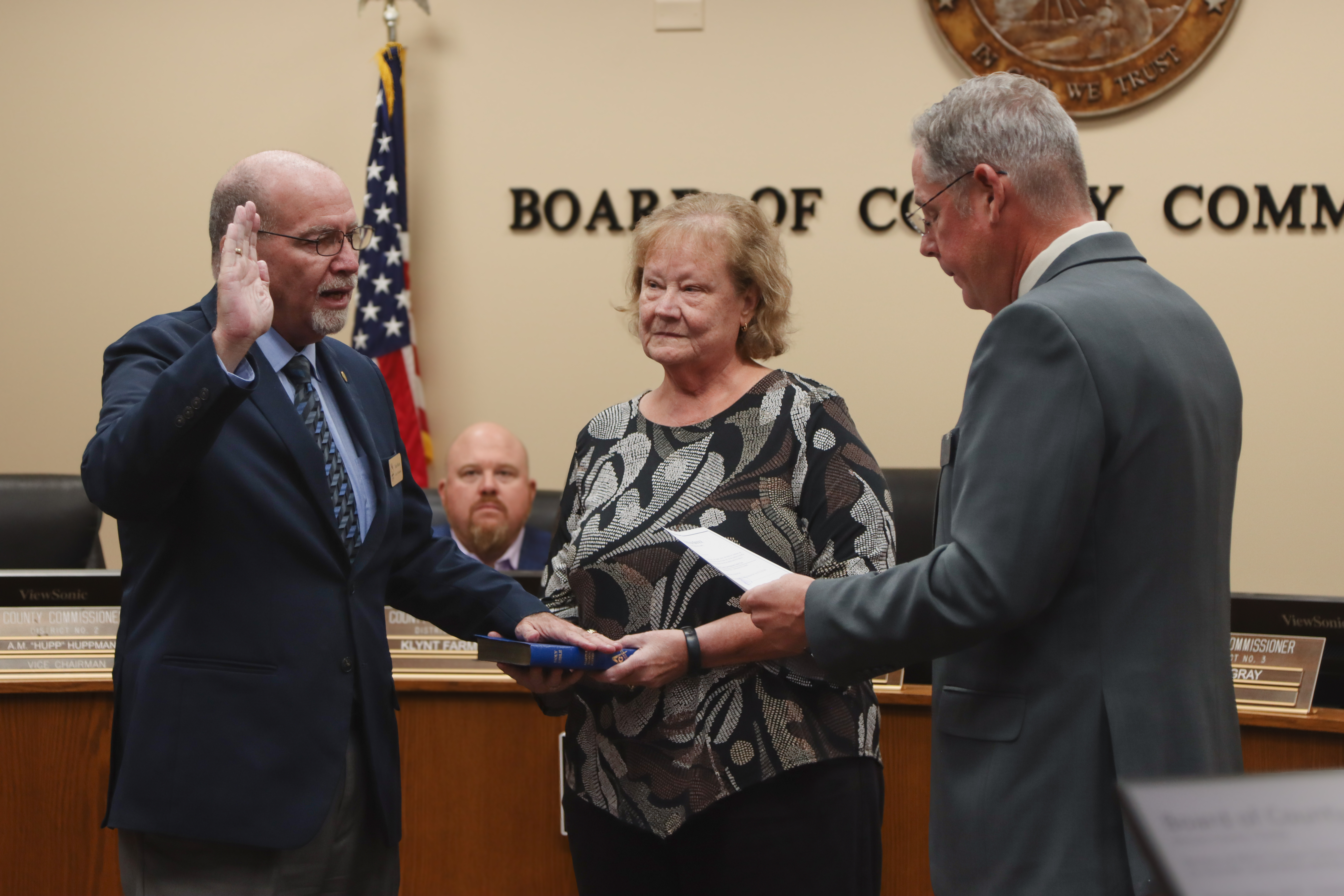 Commissioner John Martin is sworn in for another term in December 2024. From left, Martin, his wife Donna and Commissioner A.M. “Hupp” Huppmann. Photo by Ashley Chandler/News-Leader