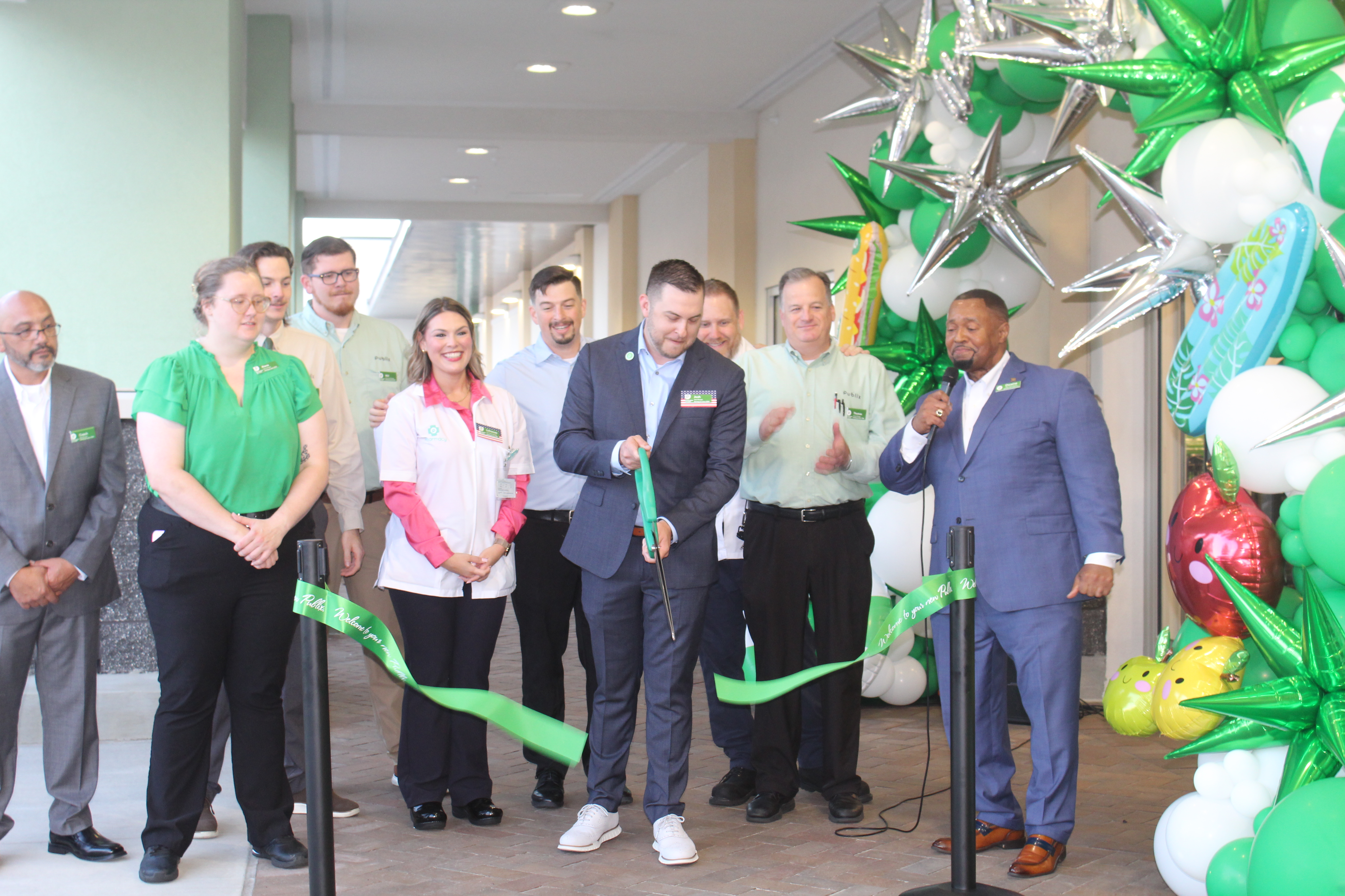 Store manager Josh Williamson cuts the ribbon for the opening of the rebuilt Publix on Thursday. 