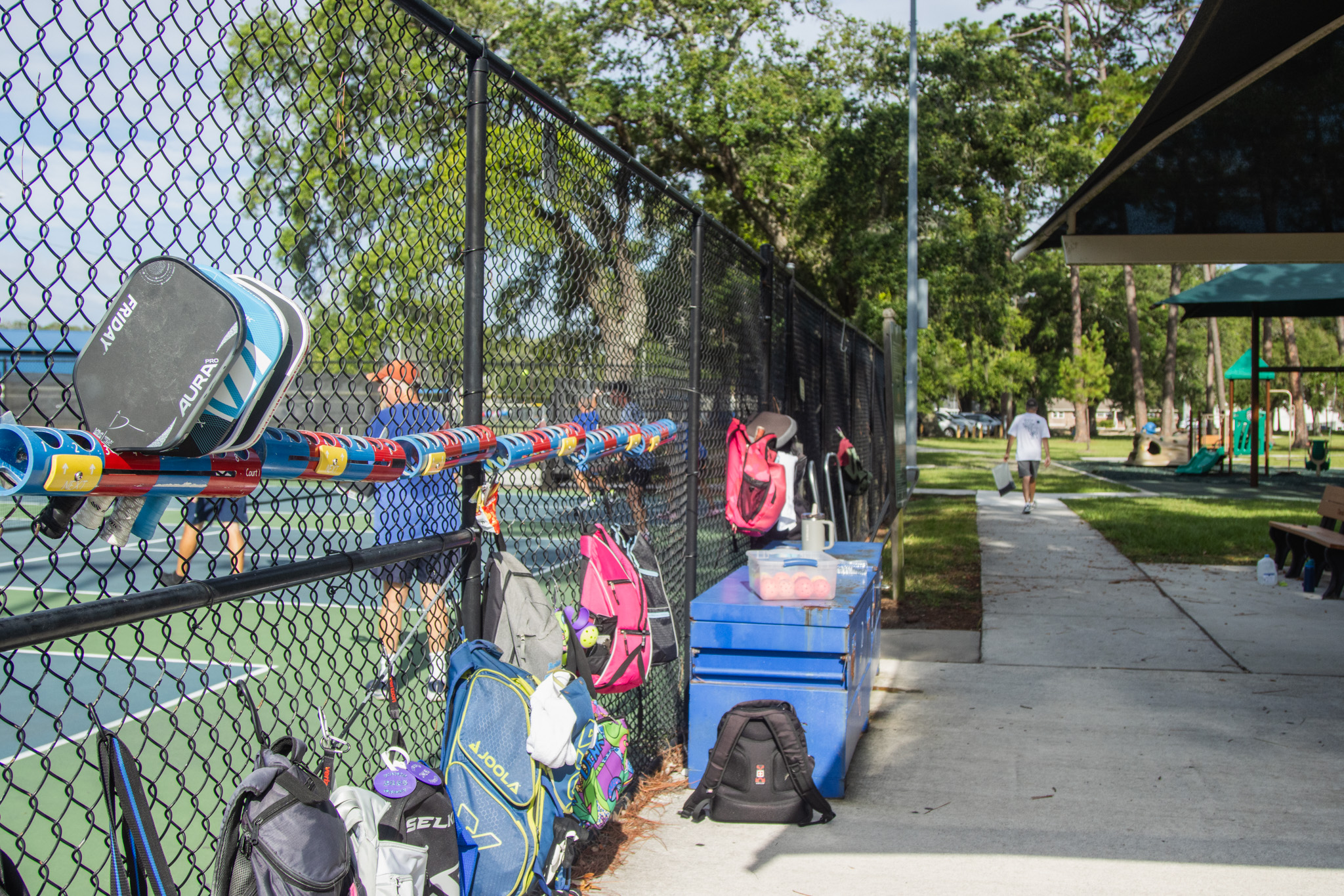 Paddles hold the place of pickleball players awaiting their turn on the courts Tuesday at Central Park. Photo by Ashley Chandler/News-Leader