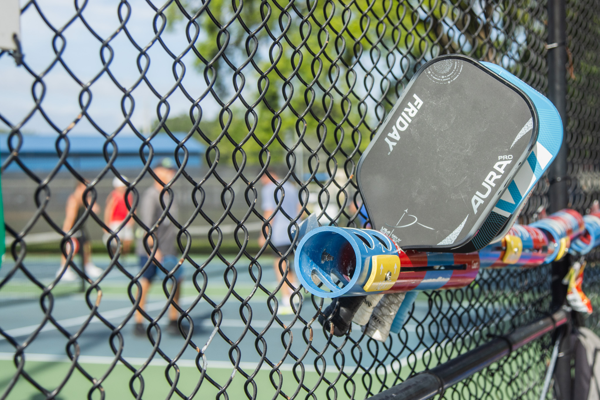 Paddles hold the place of pickleball players awaiting their turn on the courts Tuesday at Central Park. Photo by Ashley Chandler/News-Leader