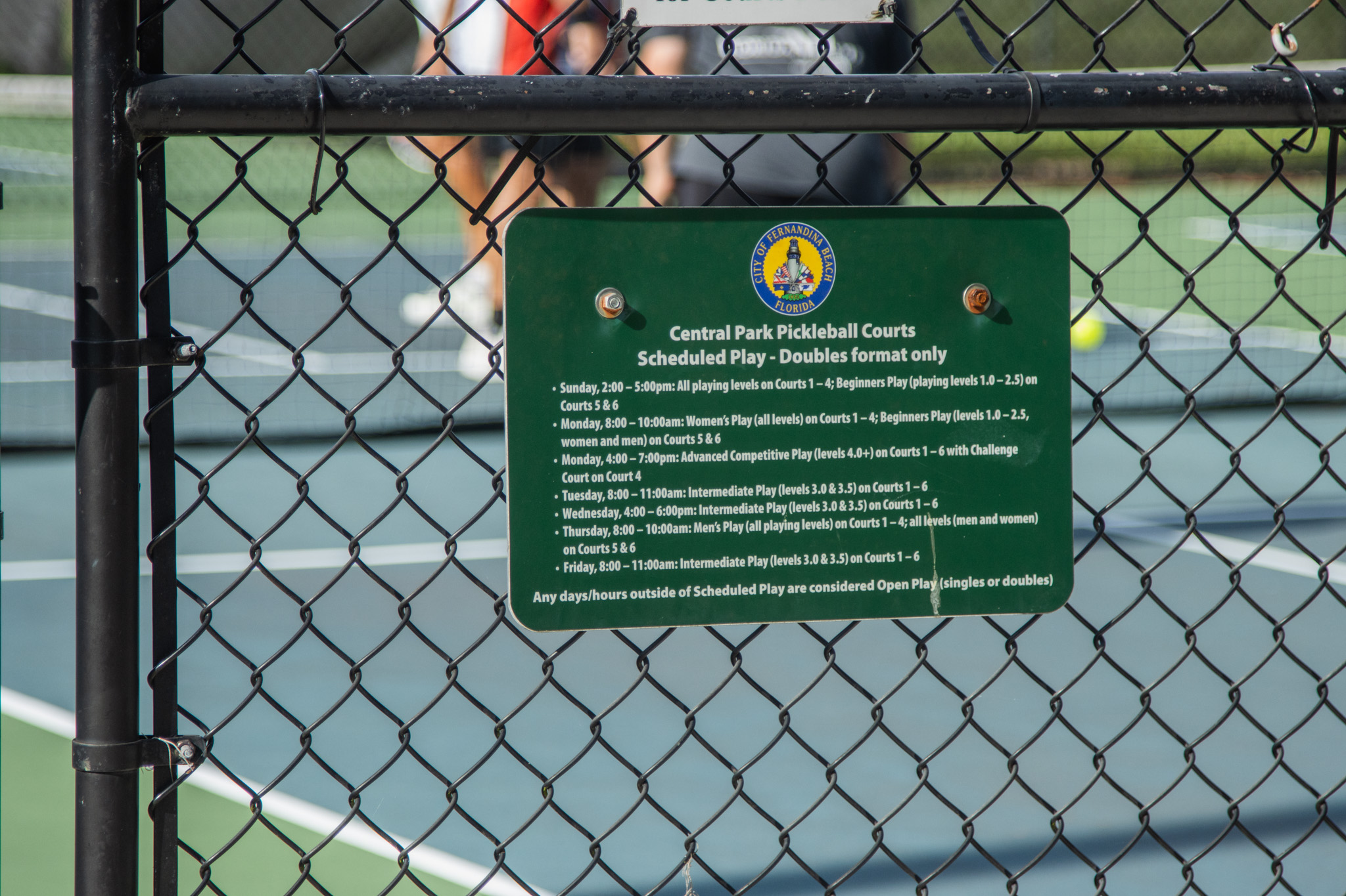 A sign at Central Park shares the scheduled play at the courts.