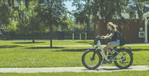 A person rides an electric bike on the sidewalk along Atlantic Avenue in Fernandina Beach.