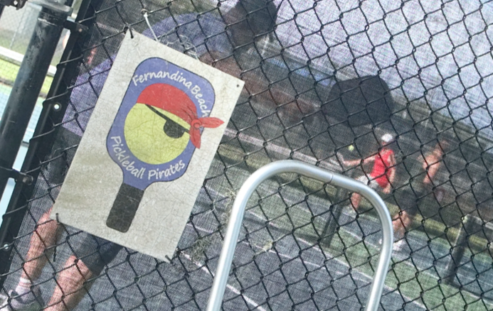 A Fernandina Beach Pickleball Pirates sign hangs on the fence Tuesday outside the Central Park pickleball courts. 