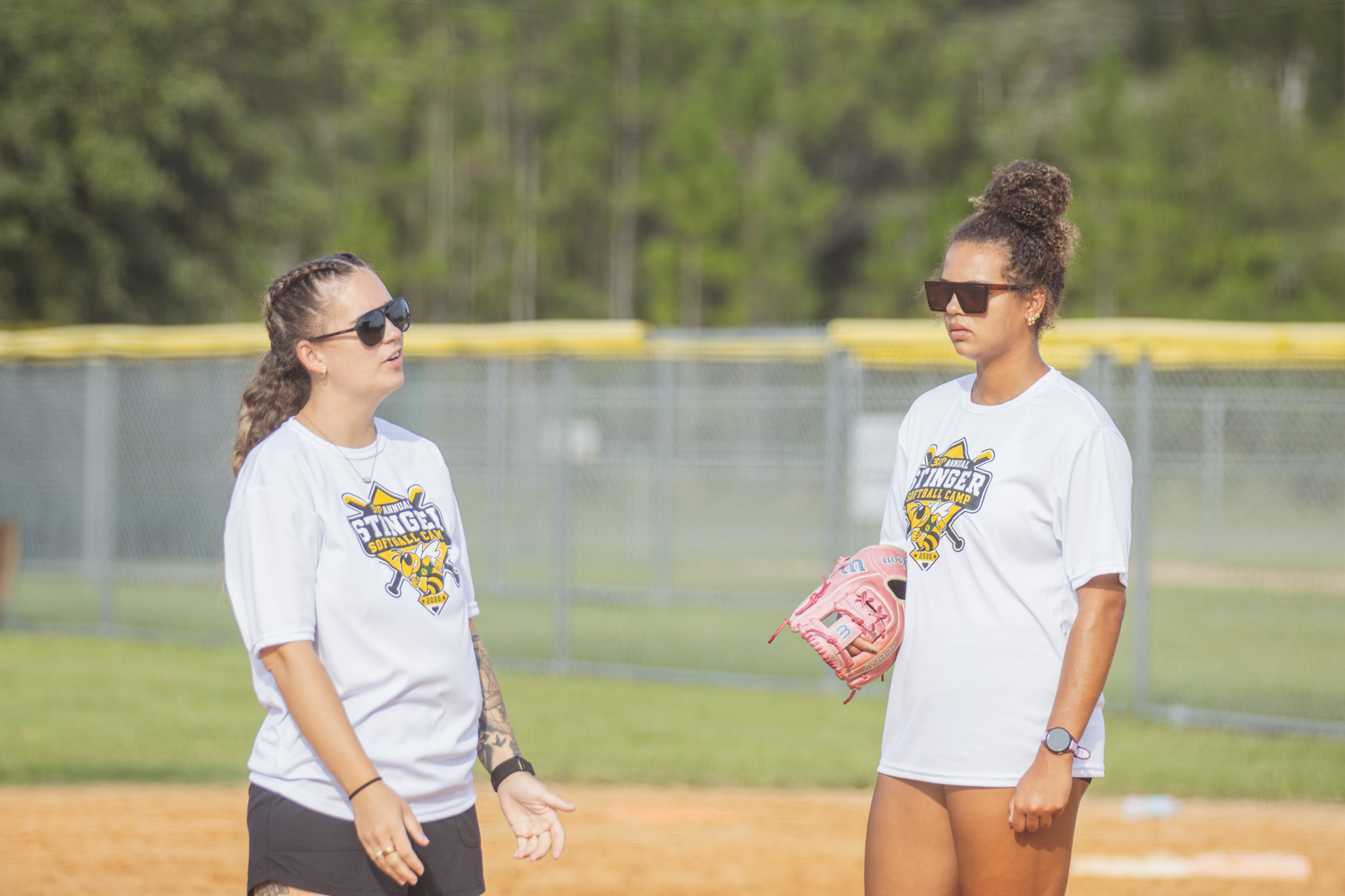 Yulee High School softball coach Cristyn Camp and Yulee softball player Carmen Overstreet talk during camp Thursday. Photo by Ashley Chandler/News-Leader
