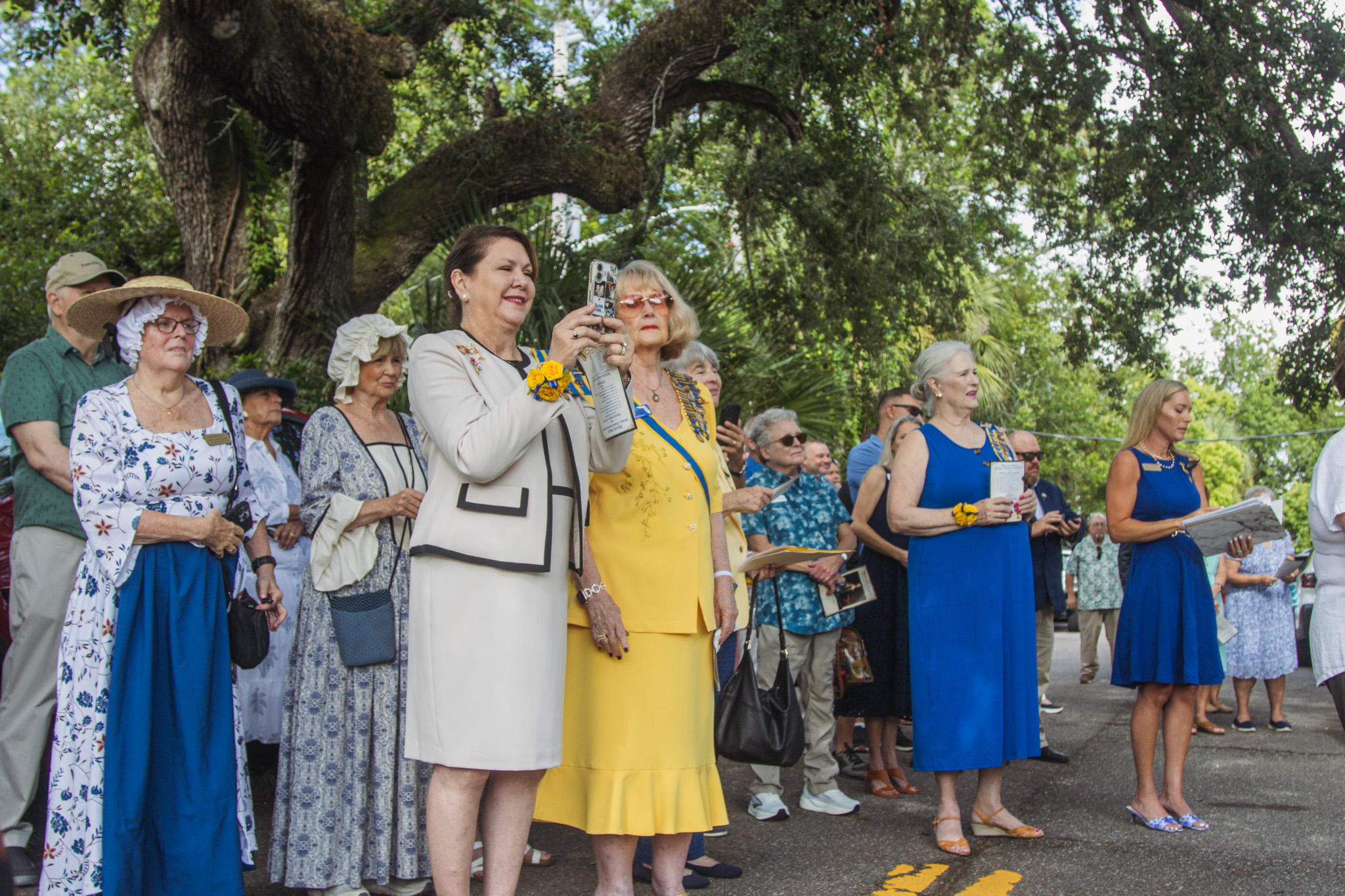 Members of the Florida Society of the Colonial Dames XVII Century, and other attendees of Saturday's event, react to the unveiling of the Princess Amelia historical marker now outside the Amelia Island Museum of History. Photo by Ashley Chandler/News-Leader