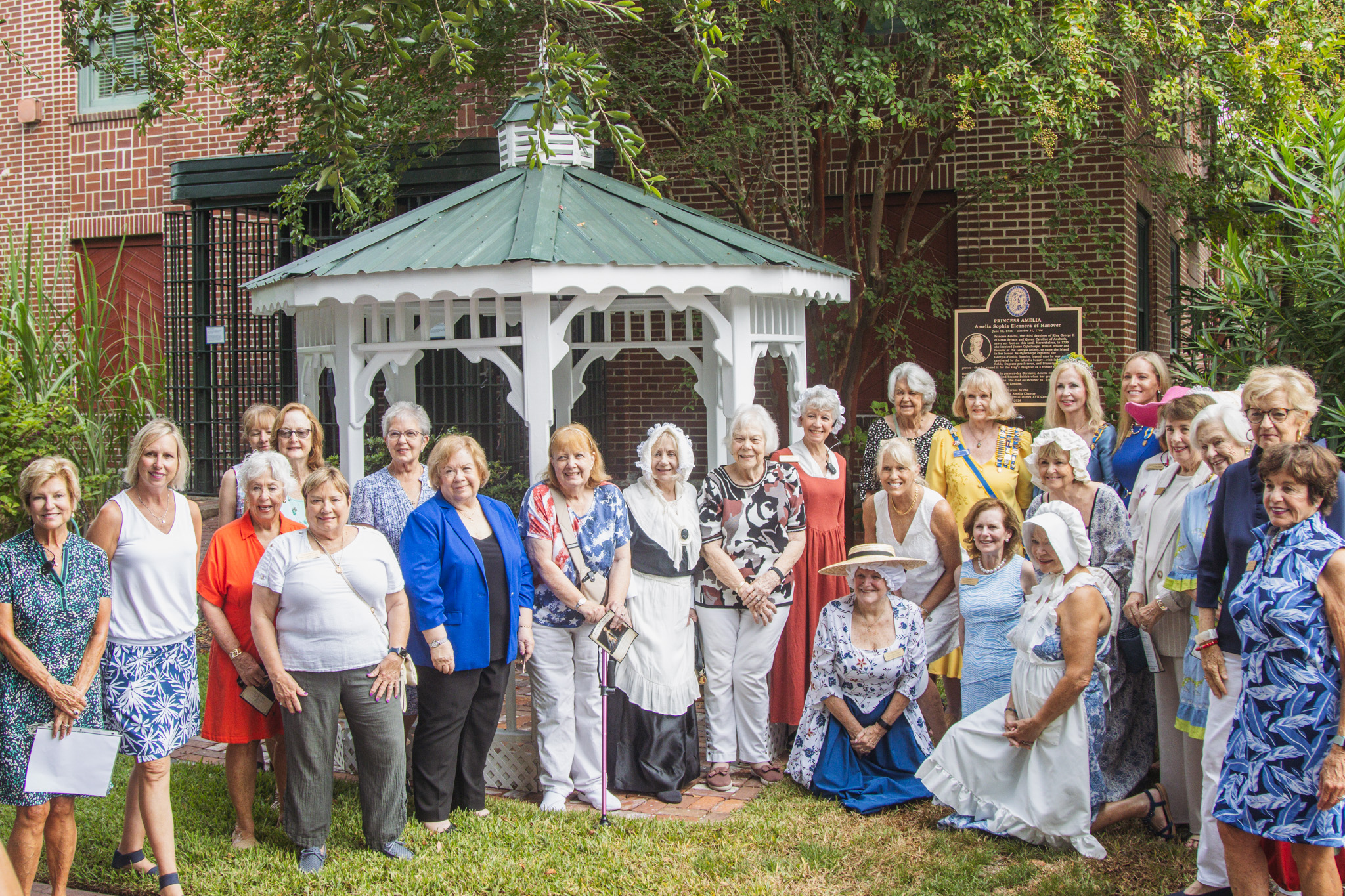 Members of the Princess Amelia Chapter of the Florida Society of the Colonial Dames XVII Century pose for a photo in front of the Princess Amelia historical marker Saturday at the Amelia Island Museum of History. Photo by Ashley Chandler/News-Leader