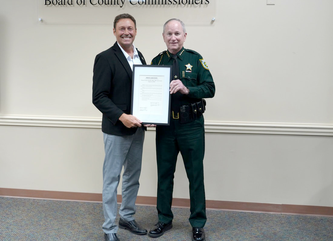 From left, Nassau County Commissioner Jeff Gray and Nassau County Sherriff Bill Leeper pose with a proclamation Monday recognizing the Nassau County Sheriff’s Office’s 200th anniversary.