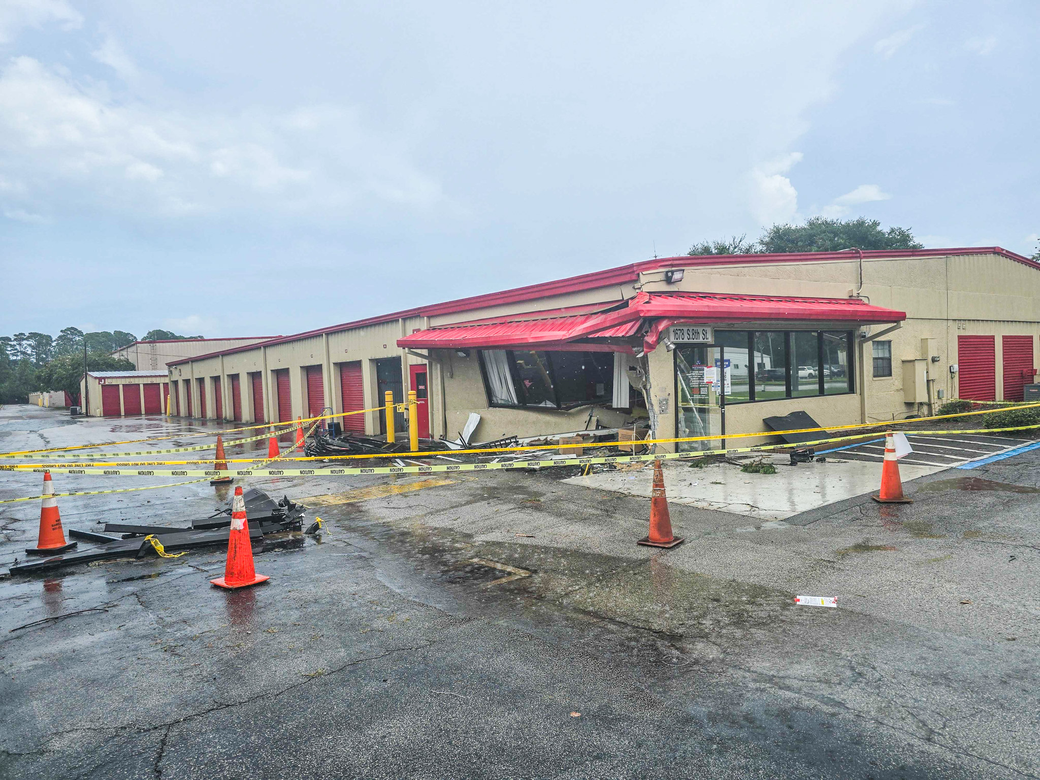 Debris is rained on Thursday afternoon at Devon Self Storage after a vehicle smashed into the building. Photo by Ashley Chandler/News-Leader