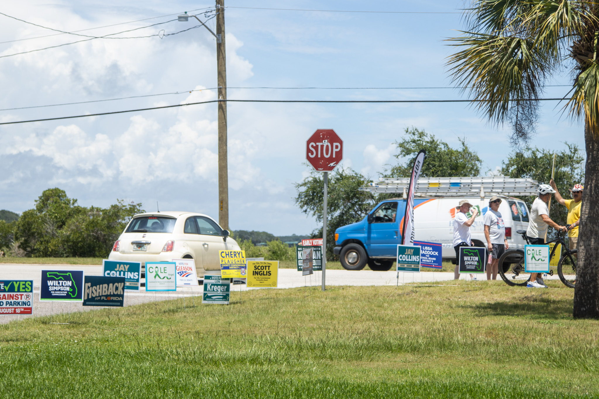 Campaign signs and campaigners are posted at the entrance of the Atlantic Recreation Center on Thursday in Fernandina Beach.