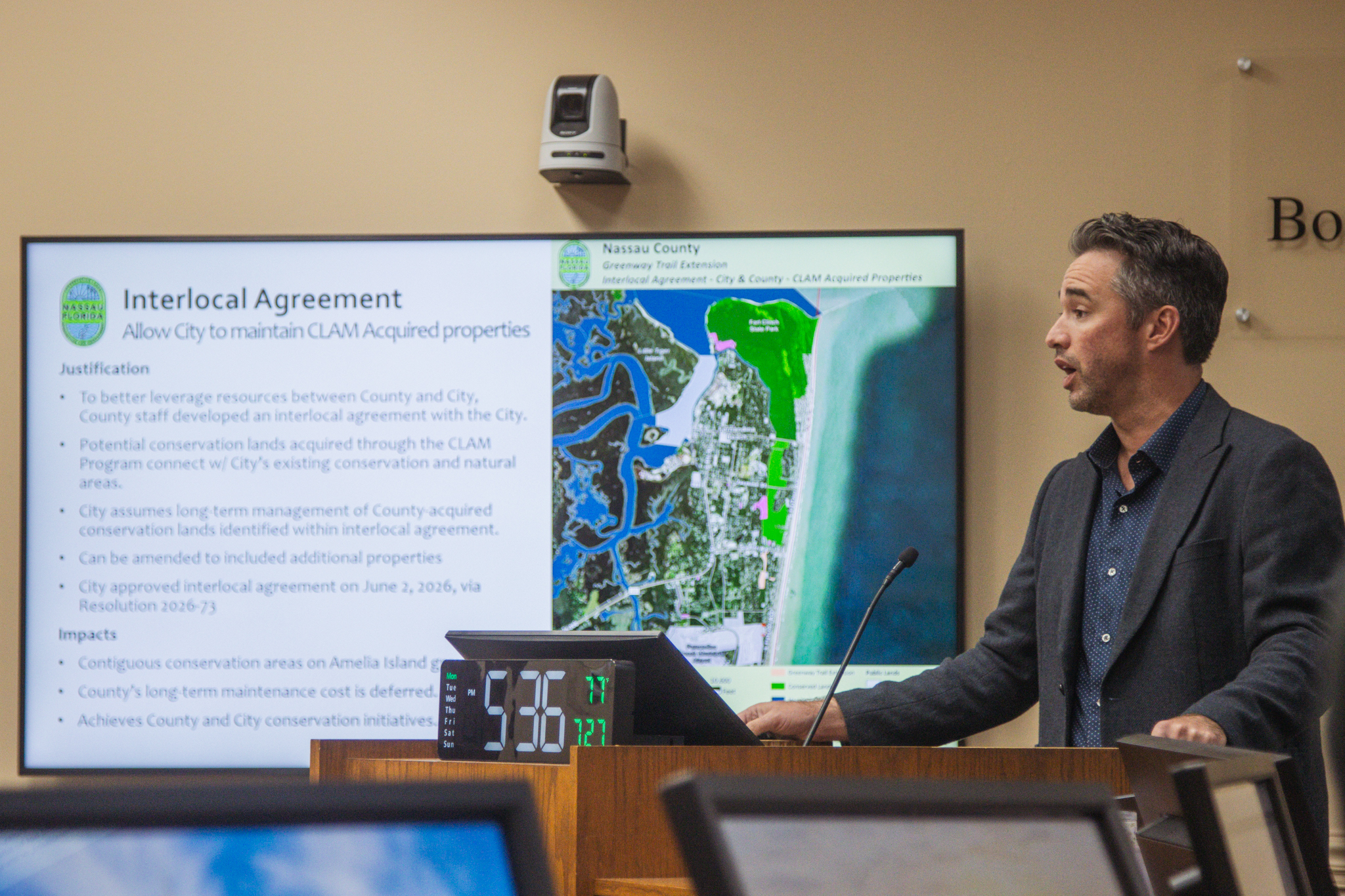 Nassau County Conservation Land Manager Taylor Clem speaks at the July 27 BOCC meeting about the Interlocal Agreement between Nassau County and the City Fernandina Beach that passes maintenance responsibility of certain CLAM properties purchased in city limits to the Fernandina Beach government. Photo by Ashley Chandler/News-Leader