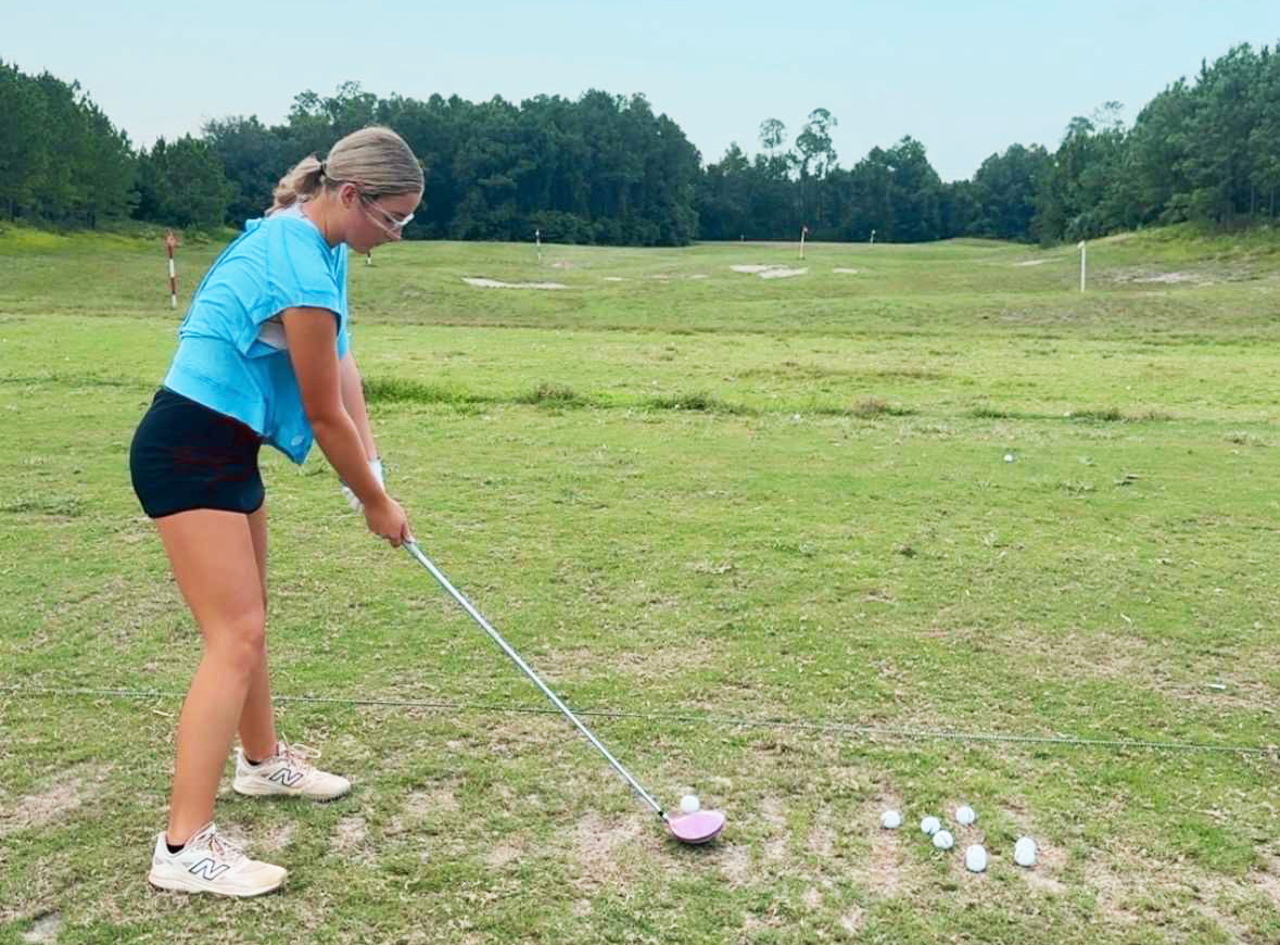 Lady Pirate golfer Harper Crews takes some swings at practice. Courtesy of YHS girls golf