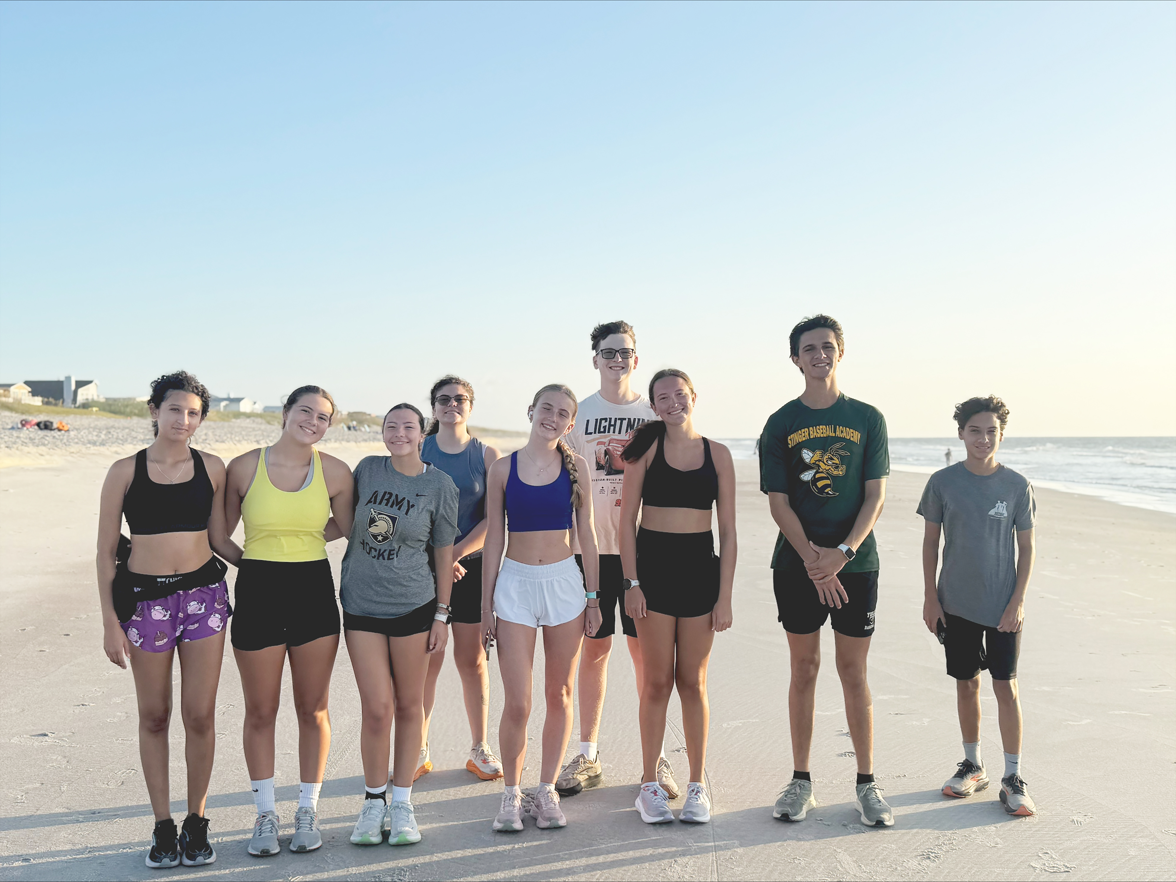 YHS boys and girls cross country runners during a summer training session on the beach. Courtesy of YHS cross country