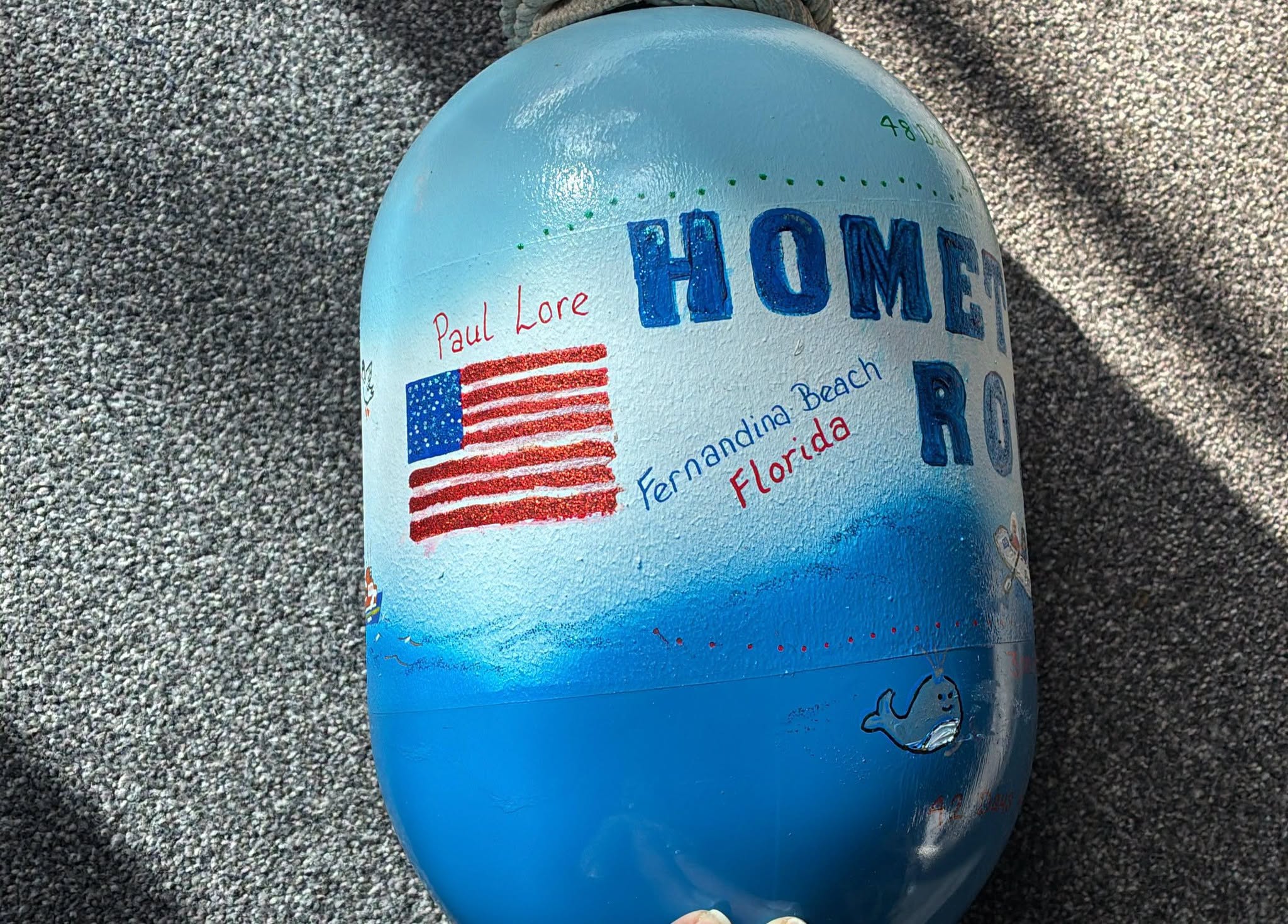 A painted buoy commemorates the completion of the row, which crossed the Atlantic Ocean twice. Submitted